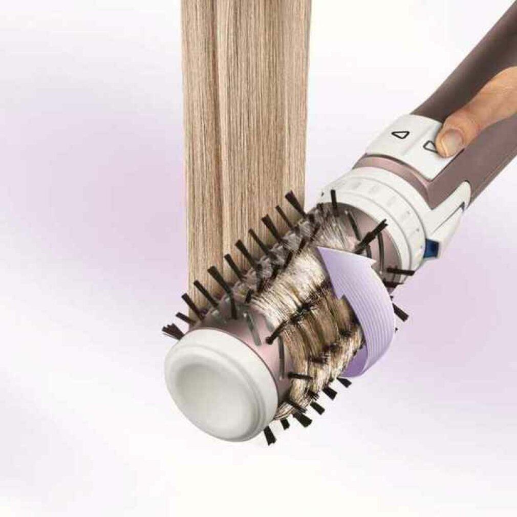 Haarstyling-Bürste in Anwendung. Bürste formt Haarsträhne. Pfeil zeigt Drehrichtung.