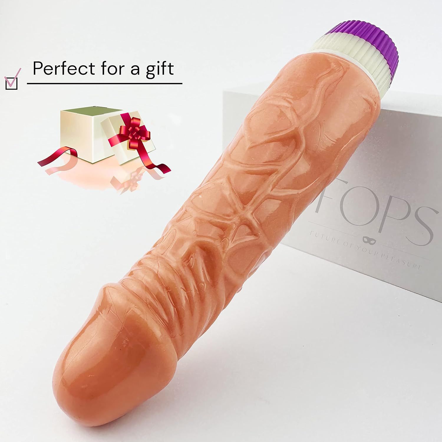 Beigefarbener Dildo mit realistischer Textur. Lila-weißes Ende. Text: Perfect for a gift. Verpackung.