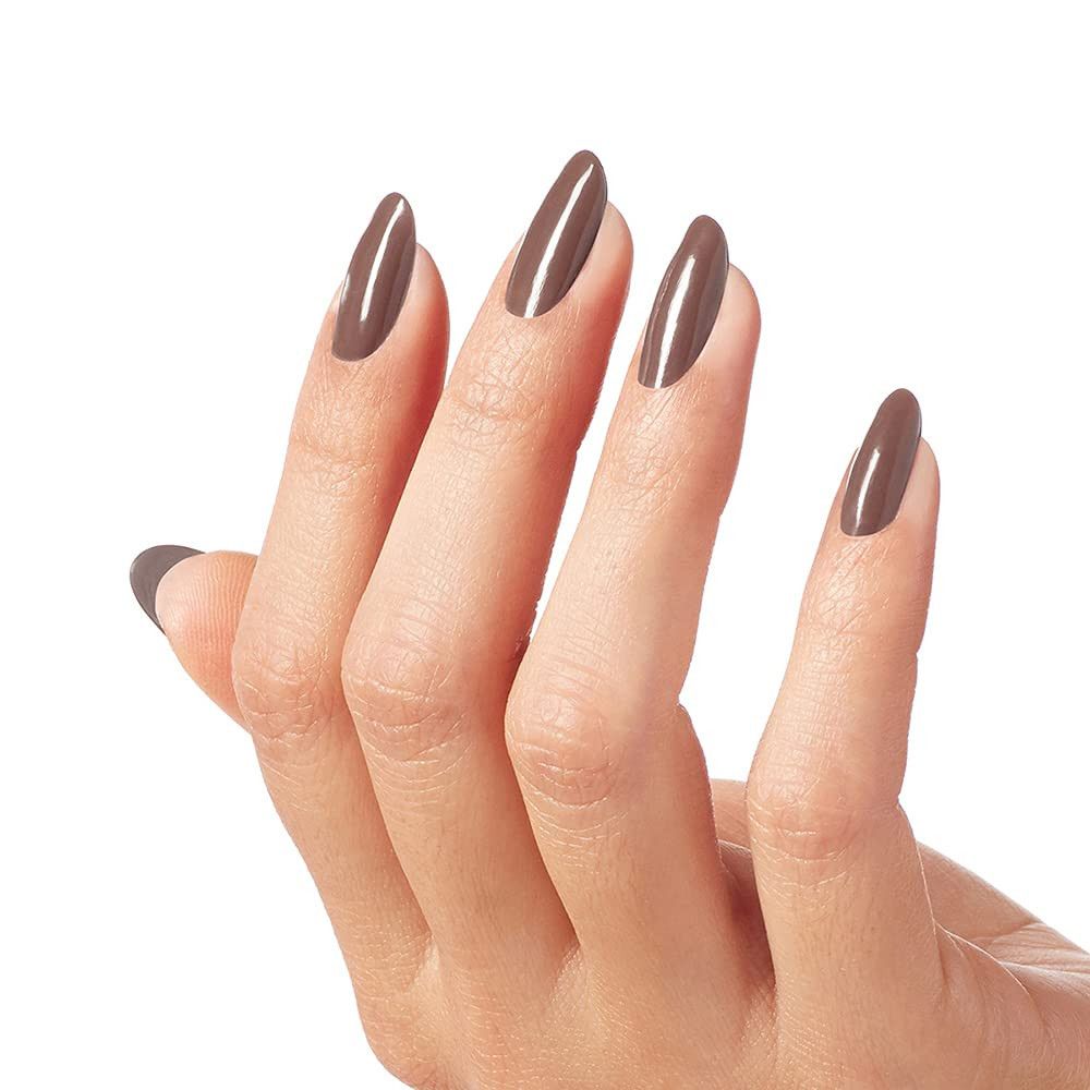 Hand mit lackierten Nägeln. Brauner Nagellack auf langen, ovalen Nägeln.