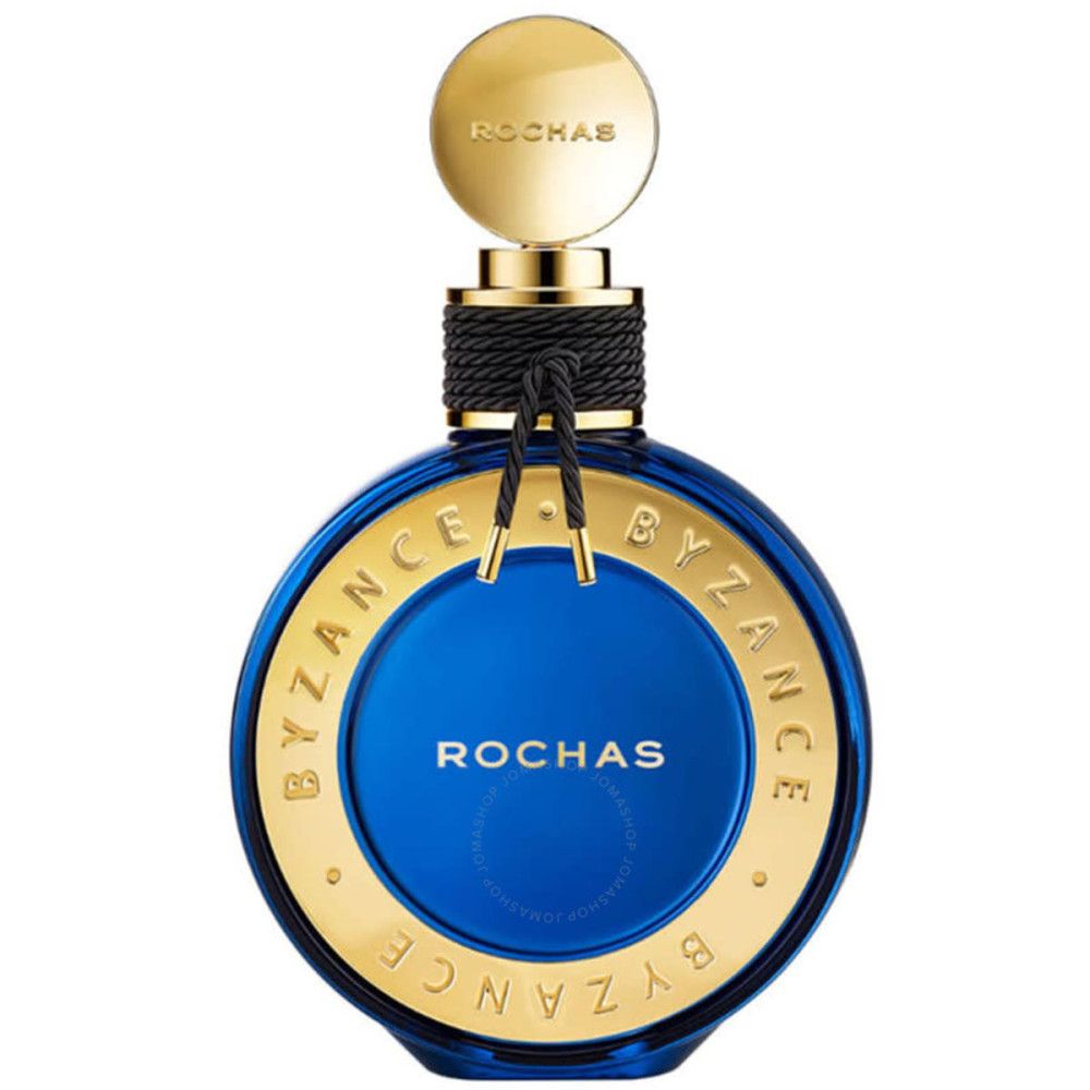 Blaue Parfumflasche mit goldenen Details. Aufschrift: BYZANCE, ROCHAS. Goldener Deckel, schwarzes Band um den Hals.