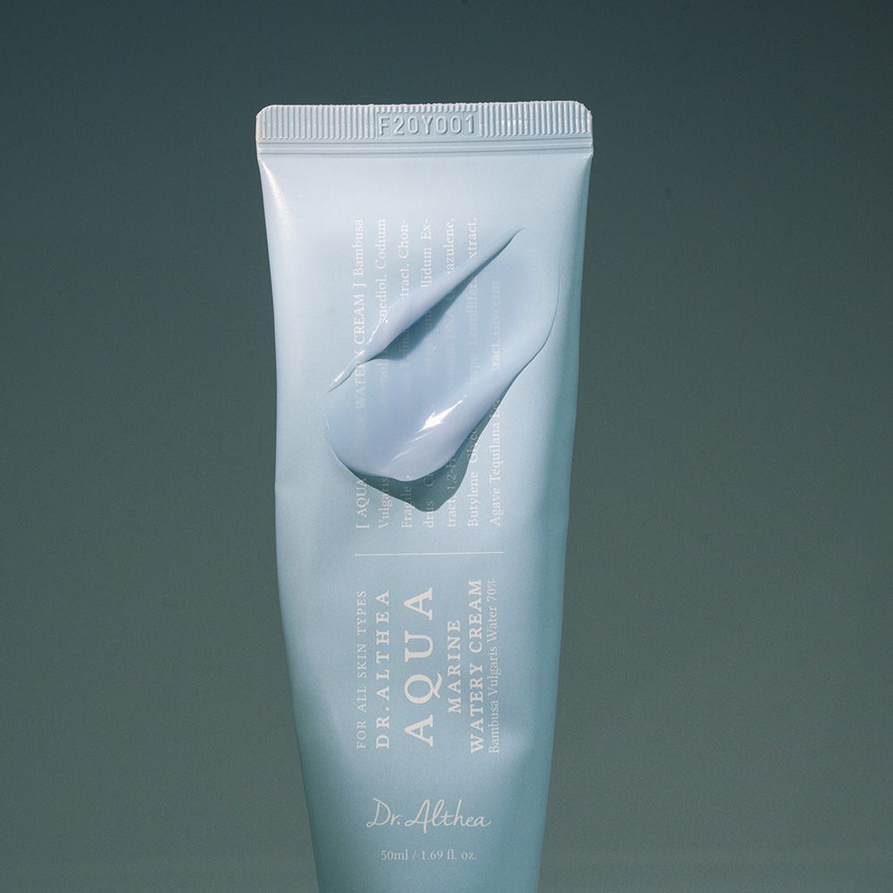 Hellblaue Tube mit Produkt. Aufschrift: Aqua Marine Watery Cream. Aufgetragenes Produkt sichtbar.