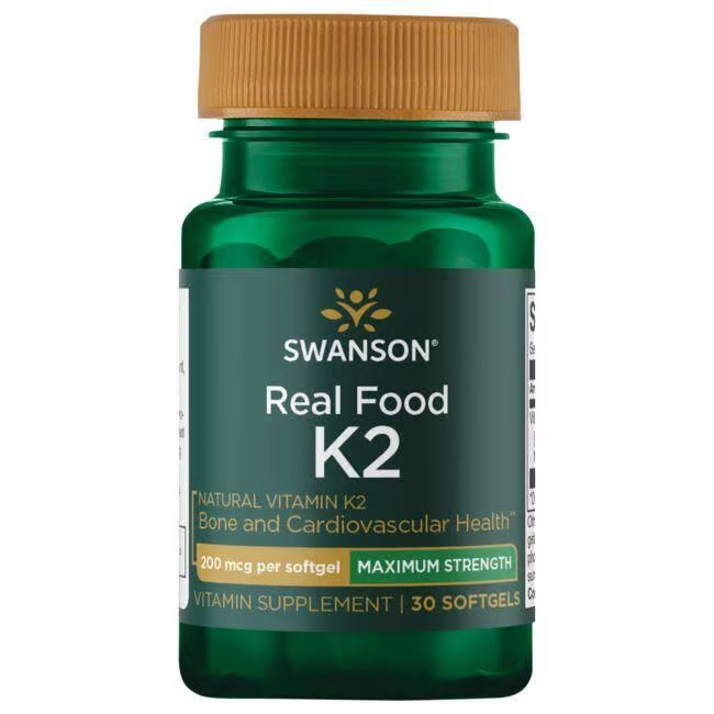 Grüne Flasche mit braunem Deckel. Aufschrift: SWANSON Real Food K2. Enthält 30 Softgels. Vitamin K2 Nahrungsergänzungsmittel.