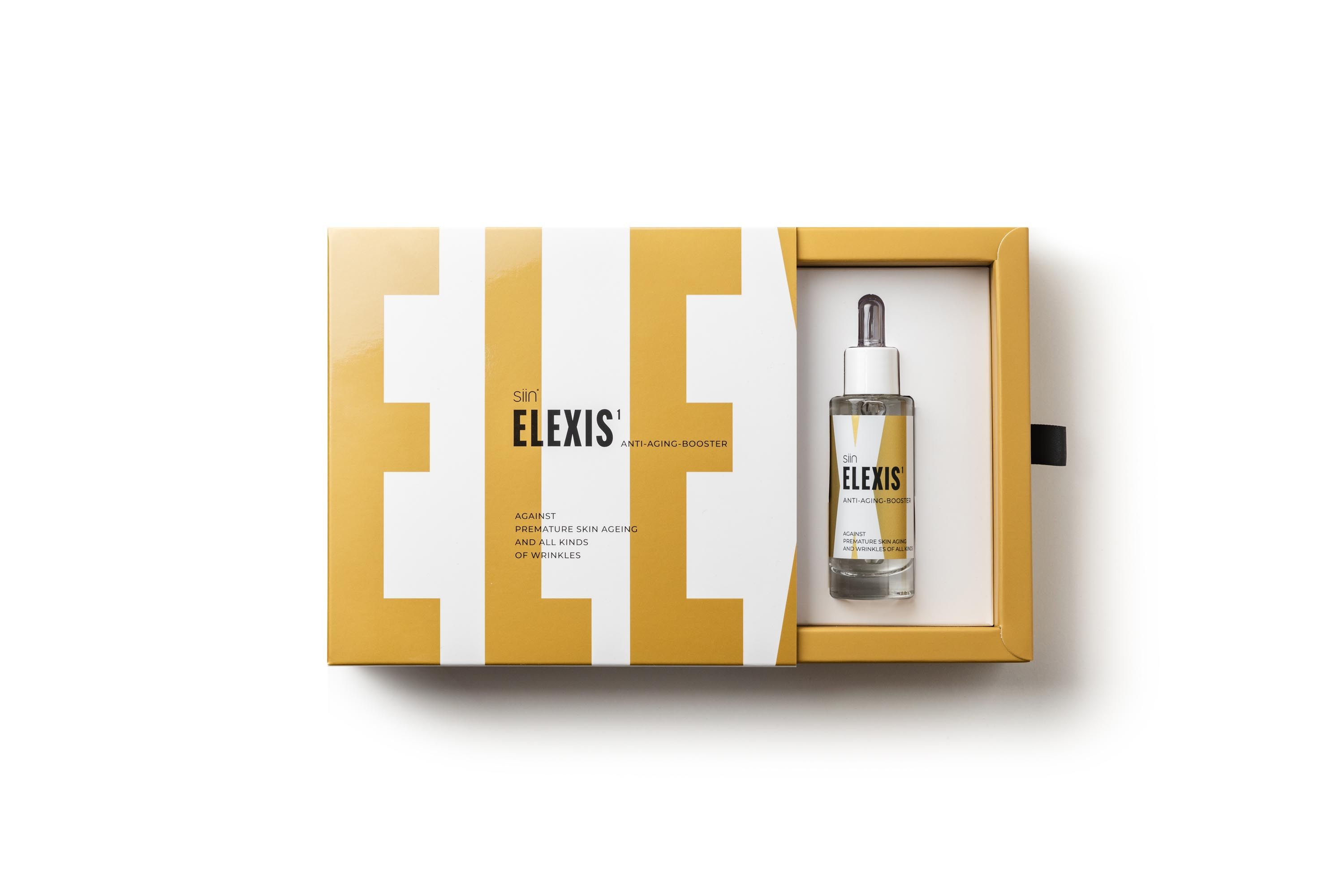 Geöffnete Verpackung mit Flasche. Aufschrift: ELEXIS. Gelbes und weißes Design.