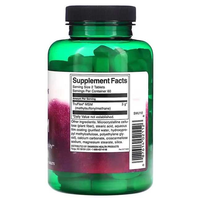 Rückansicht einer grünen Flasche mit schwarzen Deckel. Etikett mit Nährwertangaben und Inhaltsstoffen. Tabletten sichtbar.