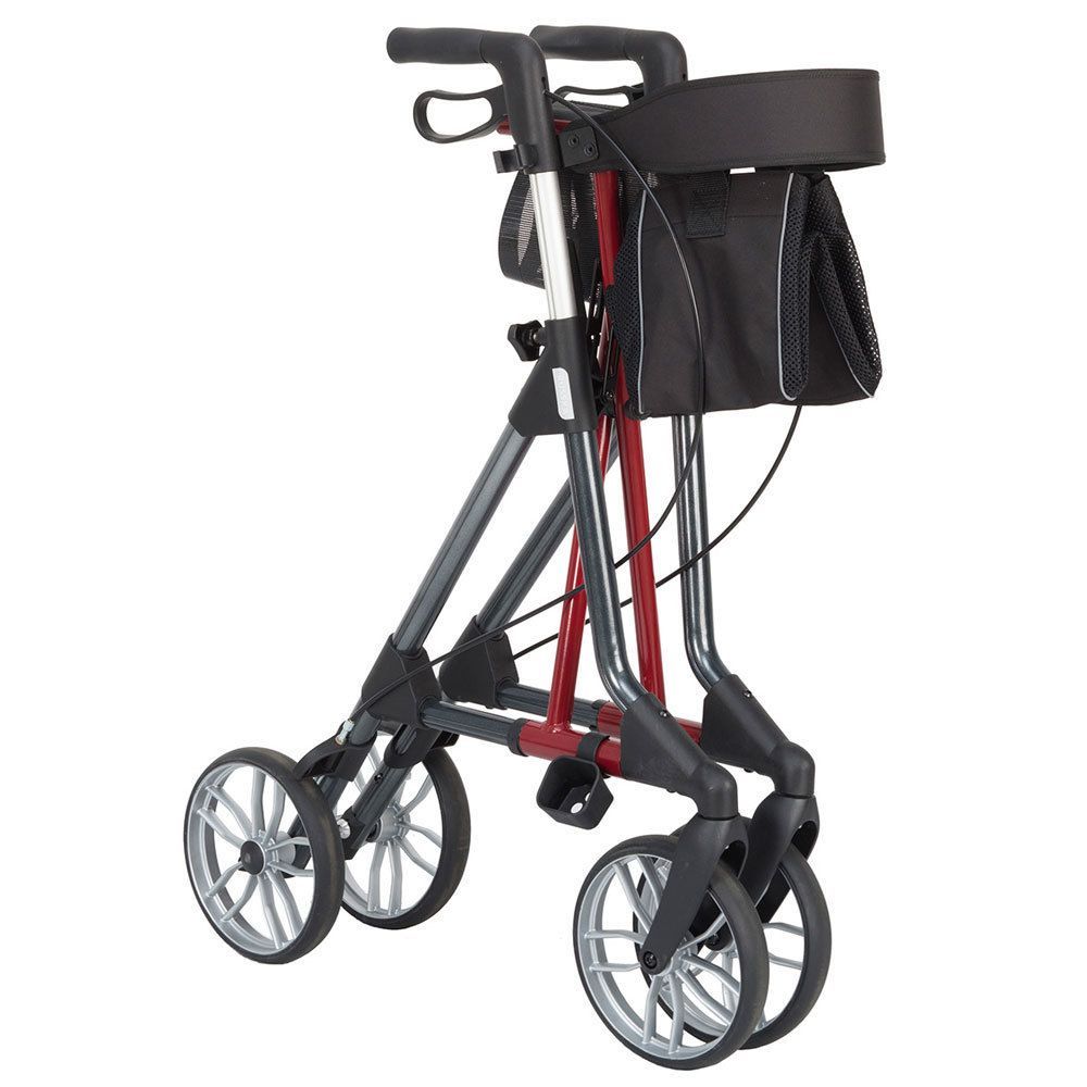 Gefalteter Rollator mit anthrazitfarbenem Rahmen und dunkelroten Elementen. Schwarzer Sitz und Tasche. Vier Räder.