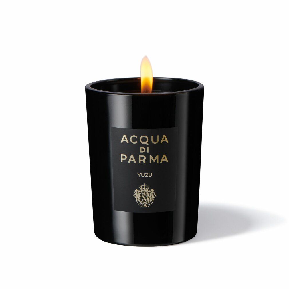 Schwarze Kerze mit Flamme. Etikett: ACQUA DI PARMA, YUZU. Logo. Zylindrische Form. Brennende Kerze.