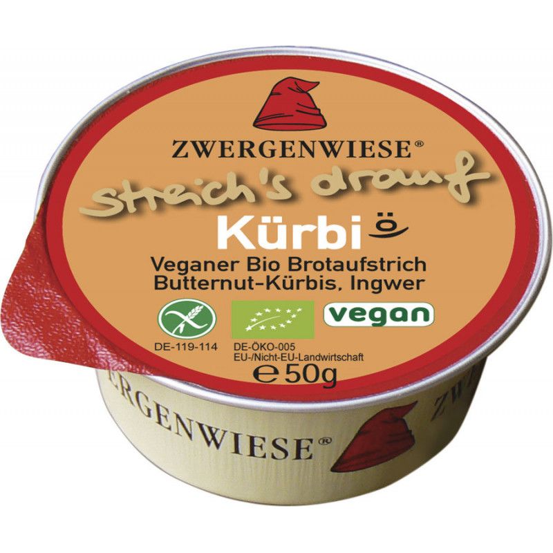 Runder Behälter mit Aufstrich. Aufschrift: Zwergenwiese, Kürbi, vegan. Bio-Siegel. Roter Deckel, silberner Rand.