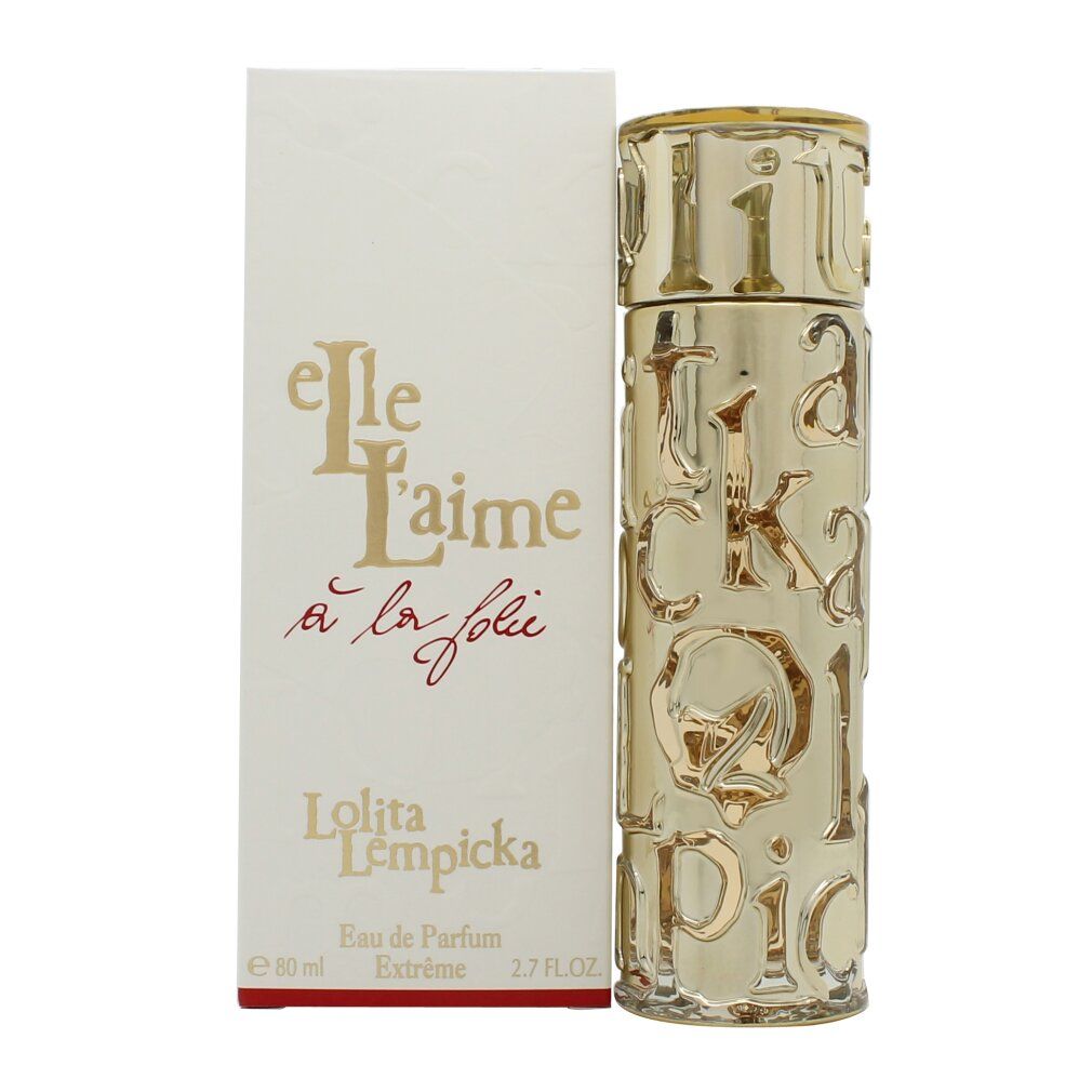 Goldfarbener Flakon und weiße Schachtel. Aufschrift: Elle L'aime à la folie, Lolita Lempicka, Eau de Parfum. Flakon mit Schriftzug.