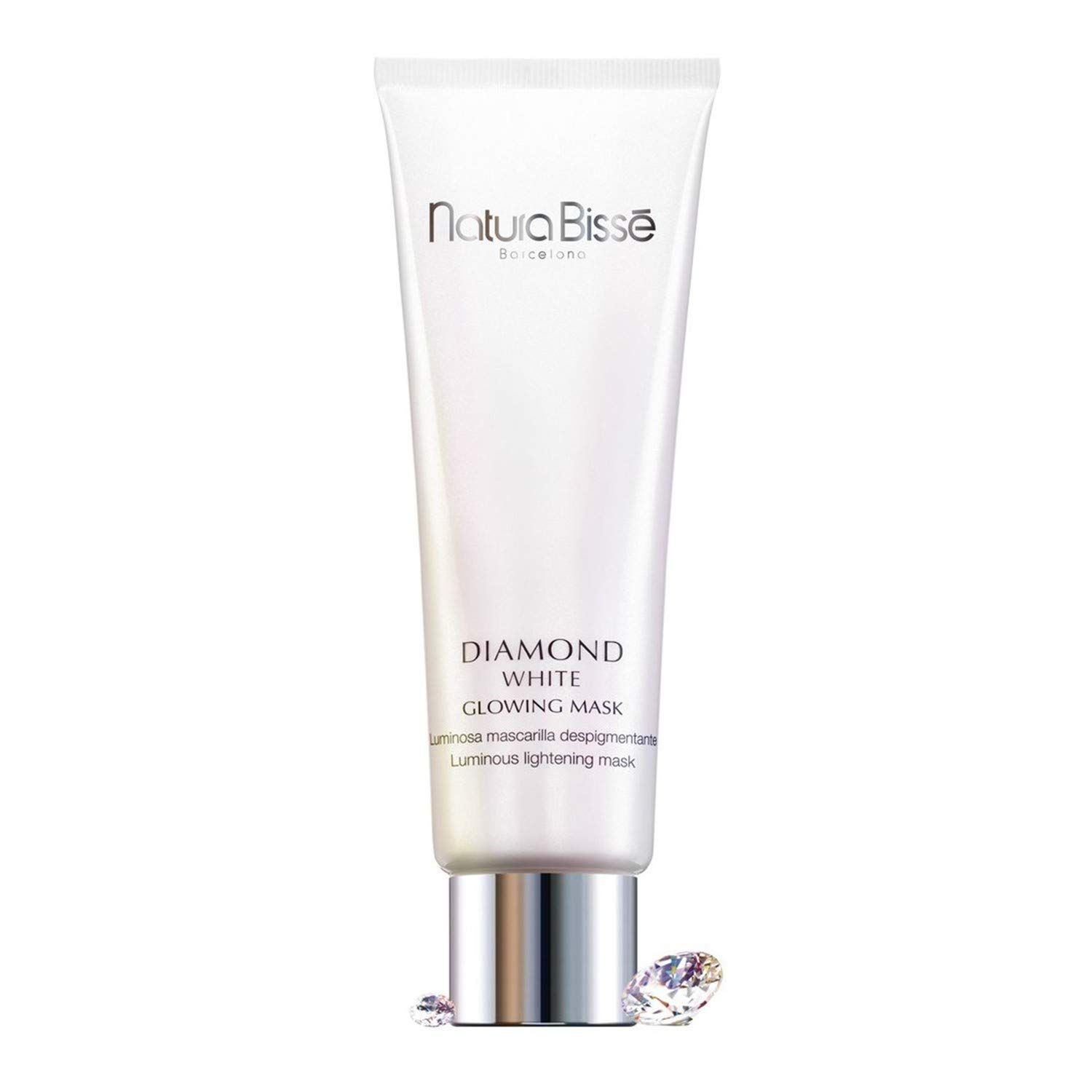 Weiße Tube mit Produkttext. Aufschrift: Natura Bissé, Diamond White Glowing Mask. Zwei Diamanten liegen daneben.