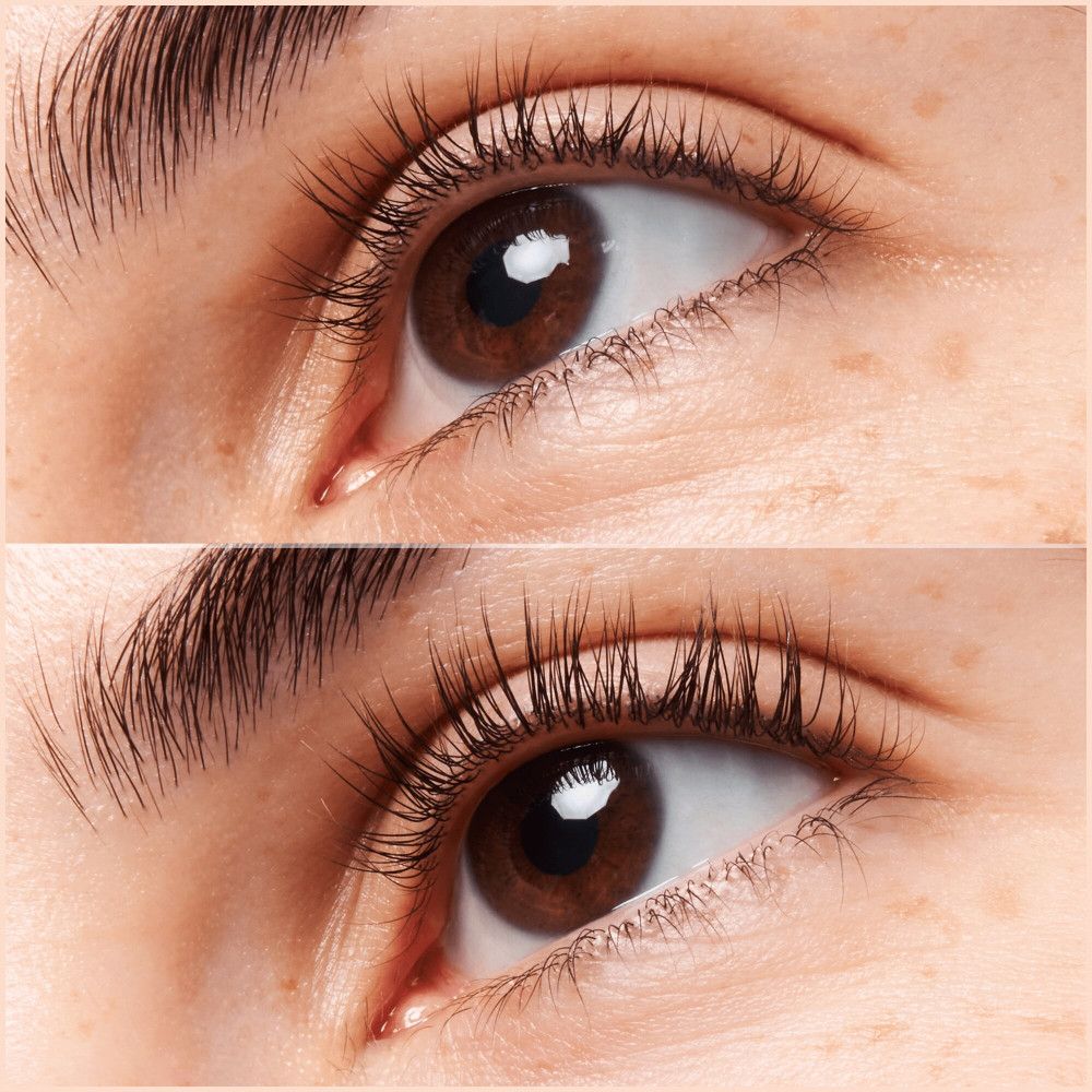 Nahaufnahme von Augen. Oben: Wimpern. Unten: Wimpern. Beide Augenbrauen sind sichtbar. Haut mit Sommersprossen. Dunkelbraune Augen.