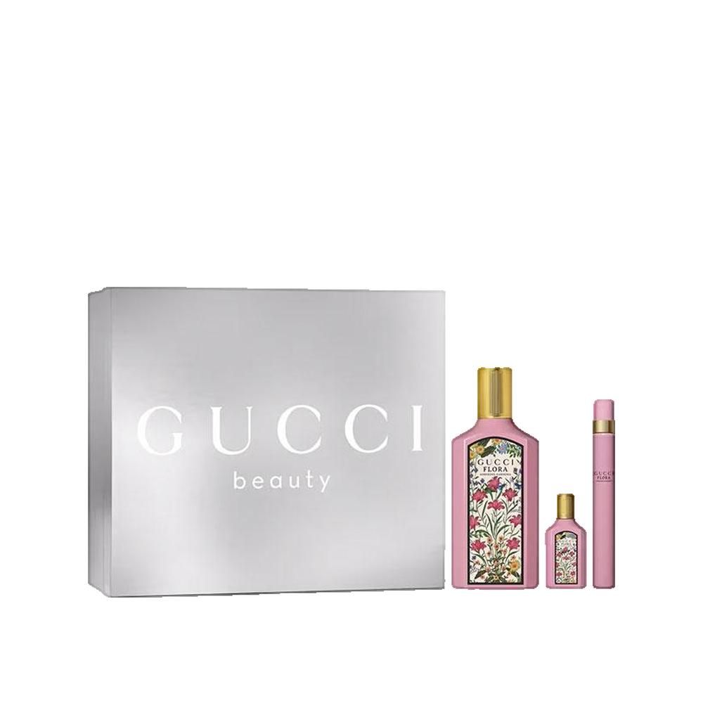 Geschenkset mit Parfümflasche, Miniatur und Zerstäuber. Silberne Box mit Gucci-Logo. Rosa Flakons mit floralem Design und goldenen Verschlüssen.