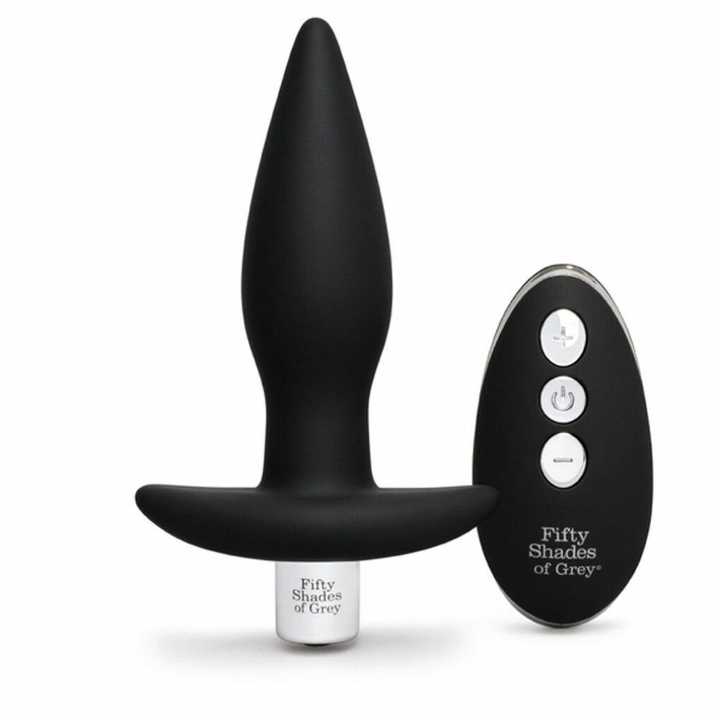 Schwarzer Analplug und Fernbedienung. Fernbedienung mit Tasten. Marke: Fifty Shades of Grey. Weißer Sockel.