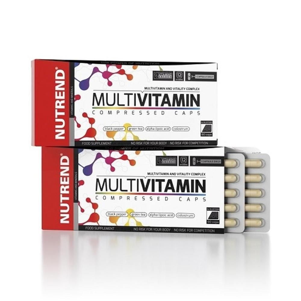 Zwei Schachteln mit "Nutrend Multivitamin Compressed Caps". Eine Schachtel geöffnet mit Tabletten. Rote und weiße Verpackung mit Text.