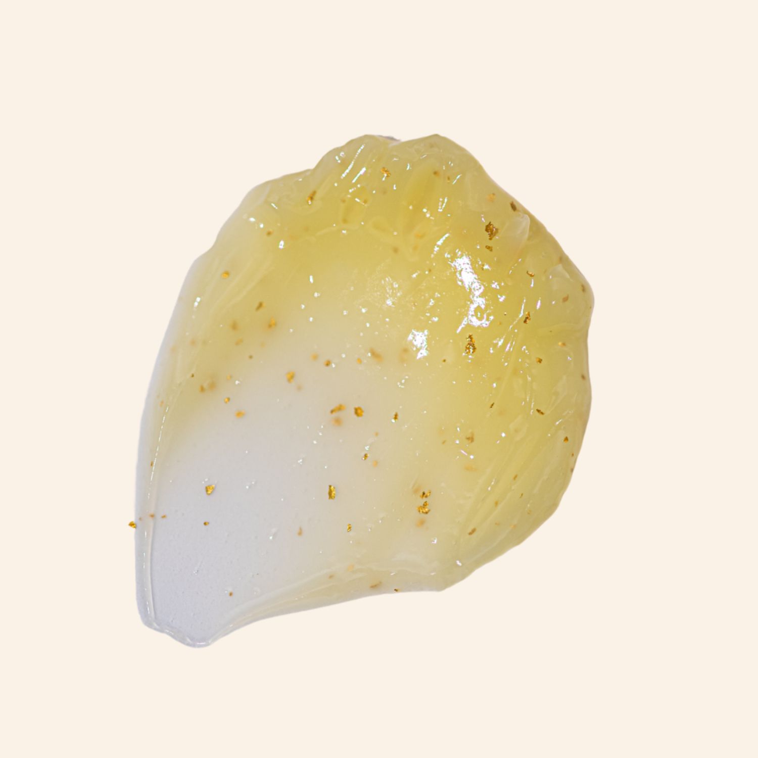 Gelartige Substanz mit goldenen Partikeln. Text: Ascorbinsäure, Squalane, Arginin, Glutathion, Koffein.