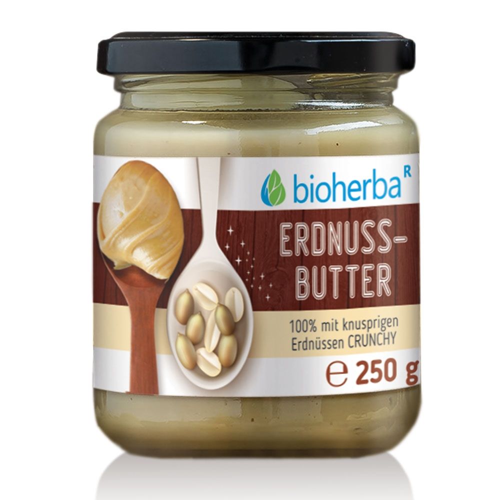 Glas mit Erdnussbutter Crunchy. Produktbezeichnung und Logo auf dem Etikett. 250 g. Schwarzer Deckel.