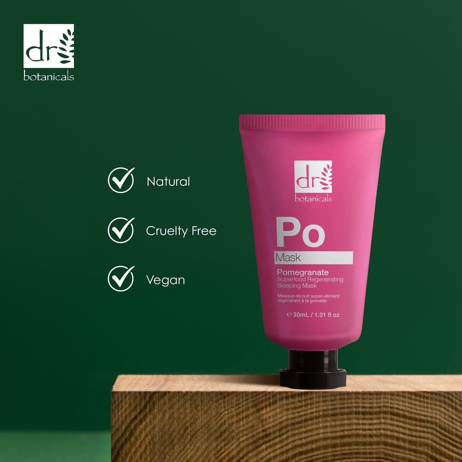 Rosa Tube auf Holzblock. Aufschrift: Dr Botanicals, Po Mask, Pomegranate Superfood Regenerating Sleeping Mask. Vegan, Cruelty Free.