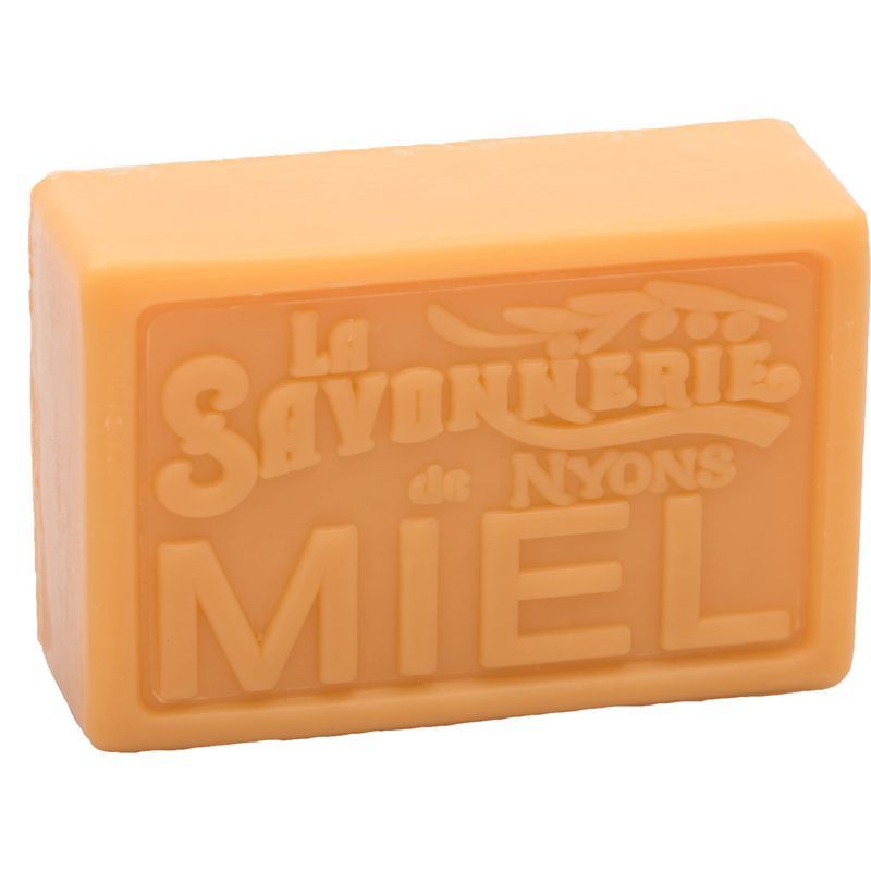 Rechteckige Seife in Honigfarbe. Geprägt: La Savonnerie de Nyons, Miel.