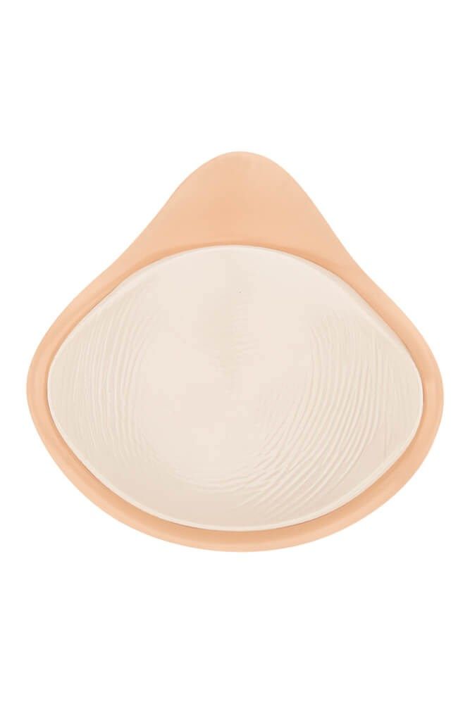 Brustprothese, tropfenförmig, beige. Innen cremefarben mit geriffelter Oberfläche.