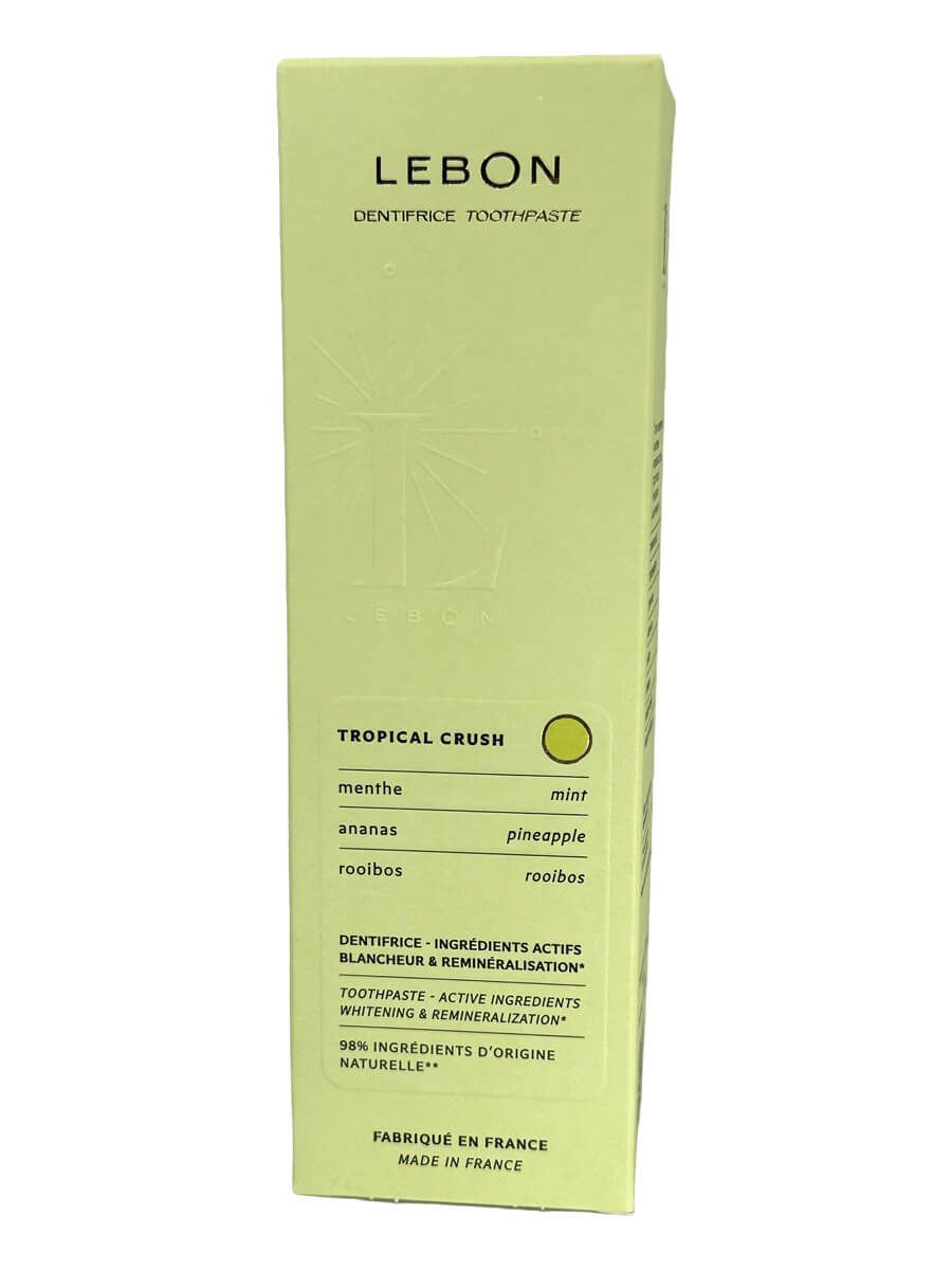 Grüne Verpackung mit LEBON-Logo und Produktinformationen. Text: Tropical Crush, Zahnpasta, 98% natürliche Inhaltsstoffe.