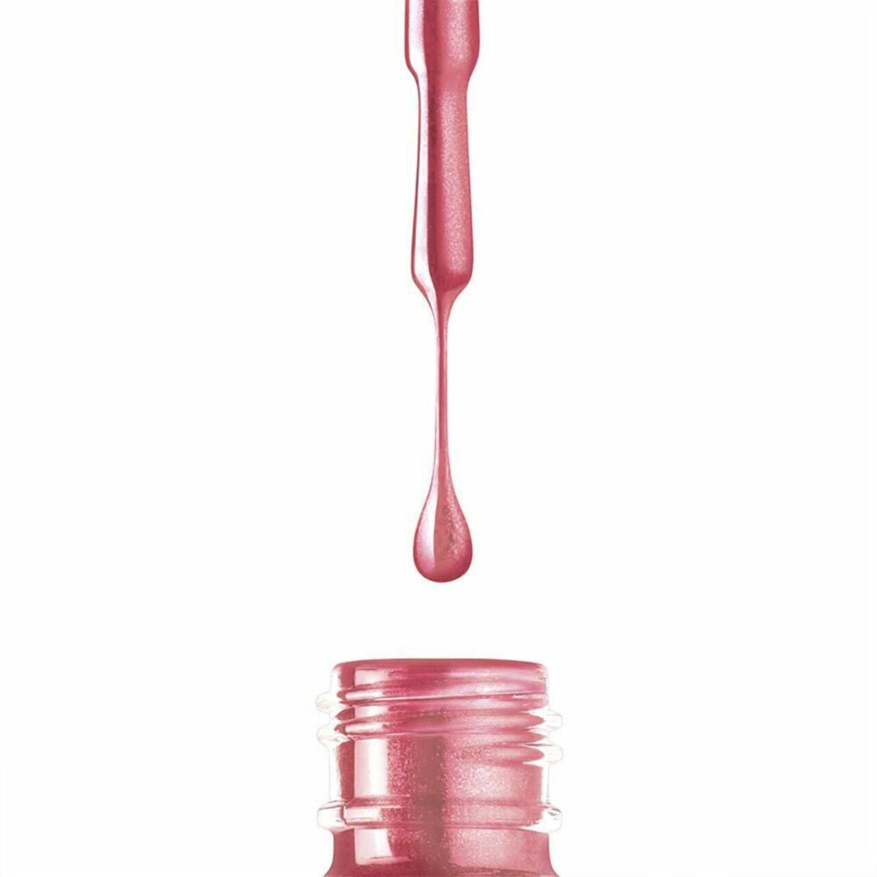 Nagellack tropft aus der Flasche. Rosa Farbe.