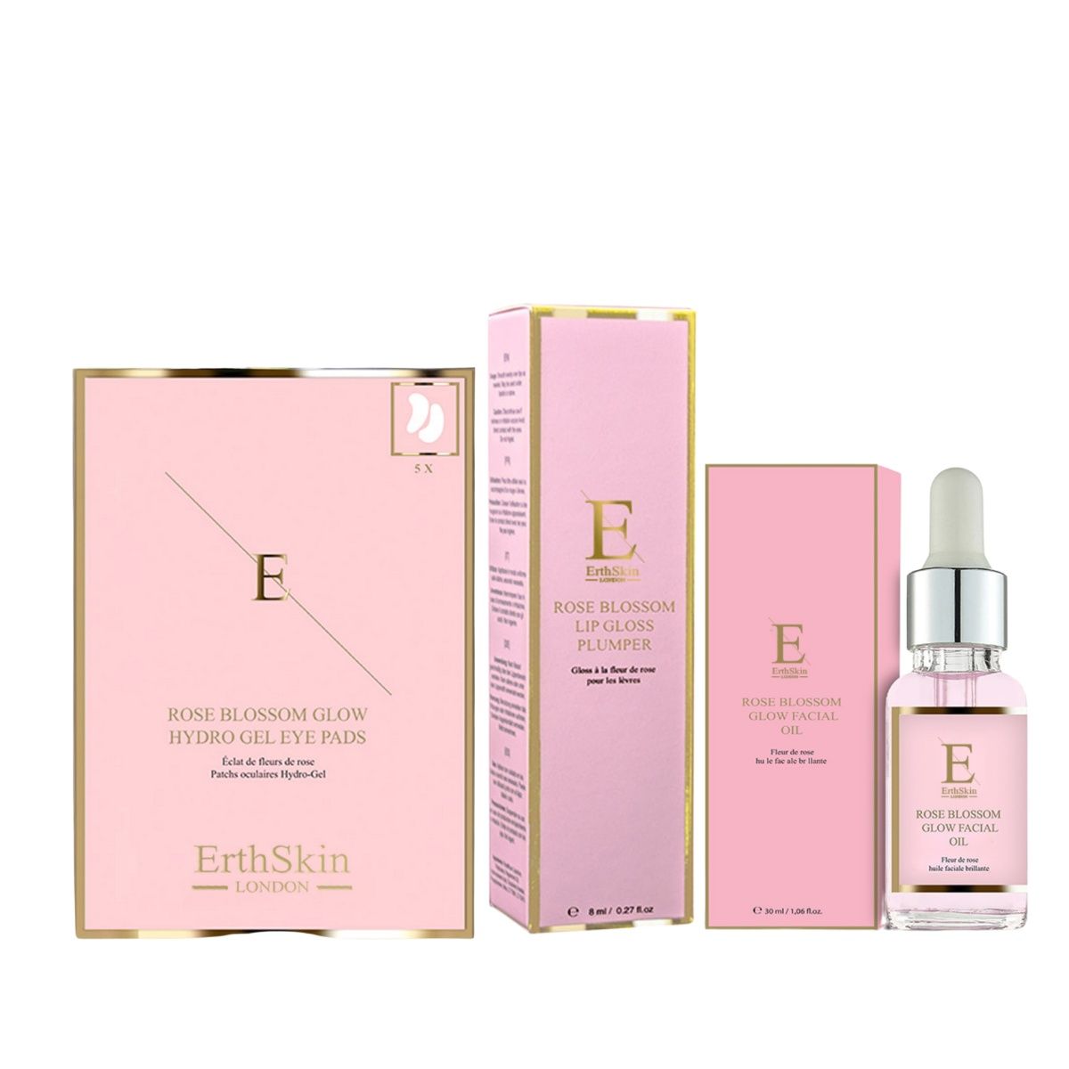 Rosa Verpackungen mit Produkten. Enthält Augenpads, Lipgloss und Gesichtsöl. Marke: ErthSkin London.