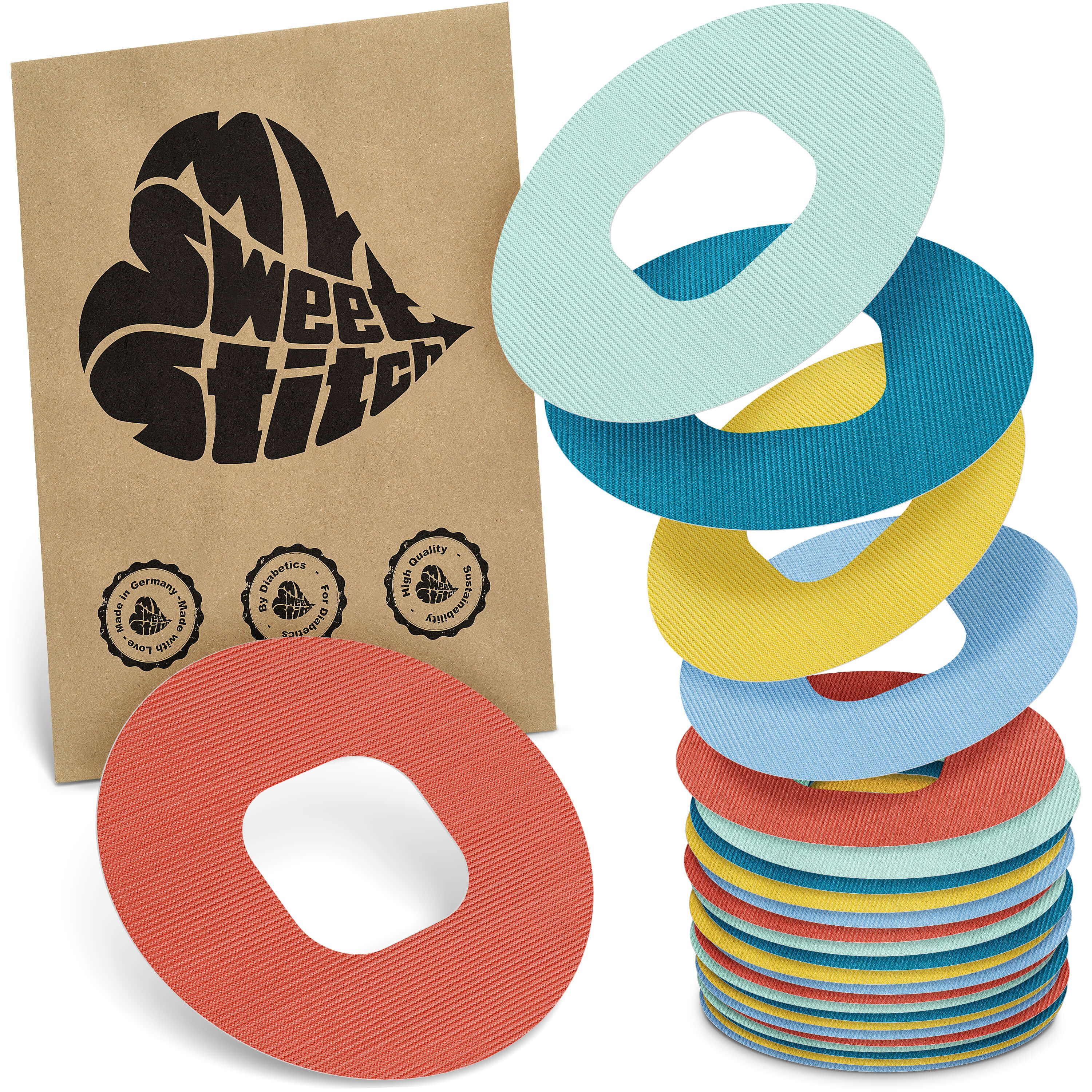 Mehrfarbige, ringförmige Pflaster mit zentraler Öffnung. Verpackung mit Logo 'My Sweet Stitch'. Zertifizierungen sichtbar.