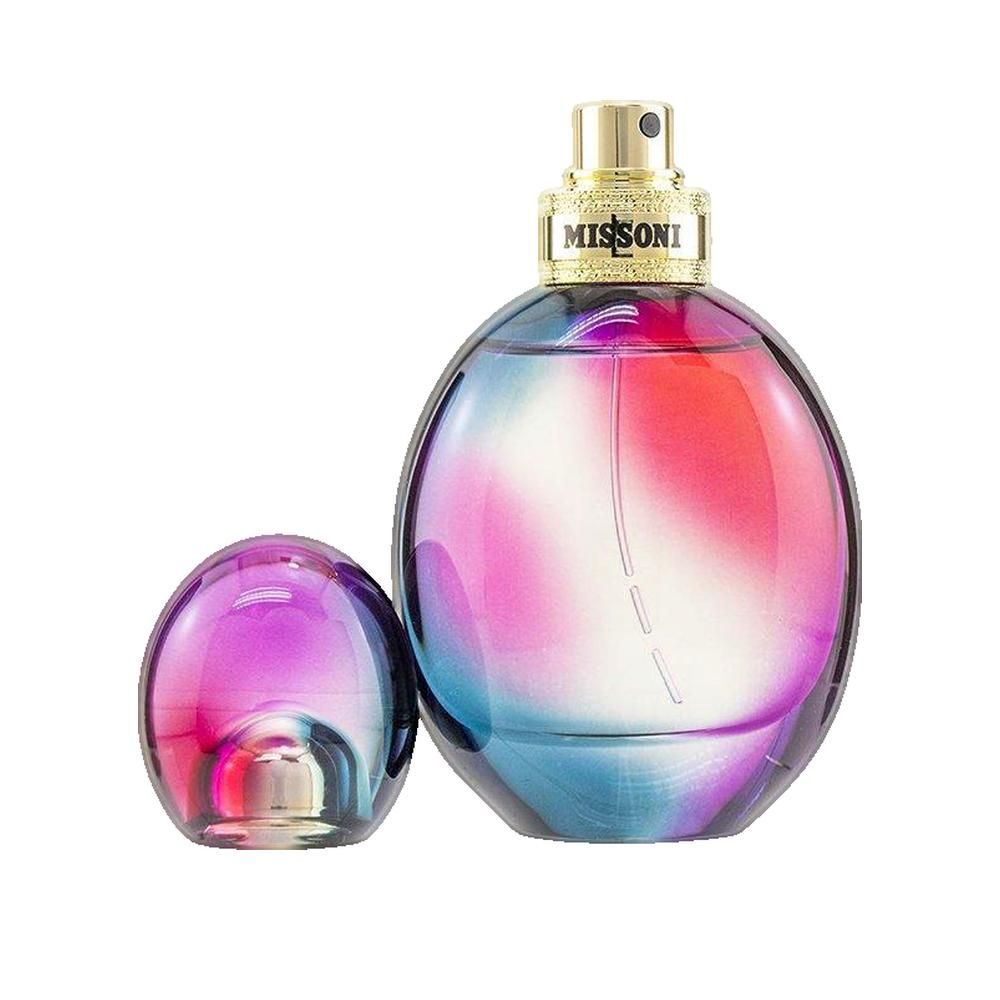 Runder Flakon mit abgenommenem Deckel. Farbverlauf von Blau zu Pink. Goldener Verschluss mit "MISSONI" Schriftzug.