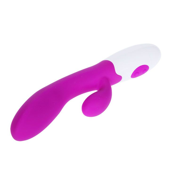 Lila Vibrator mit weißem Kopf. Zwei Knöpfe. Ergonomische Form. Aus Silikon.