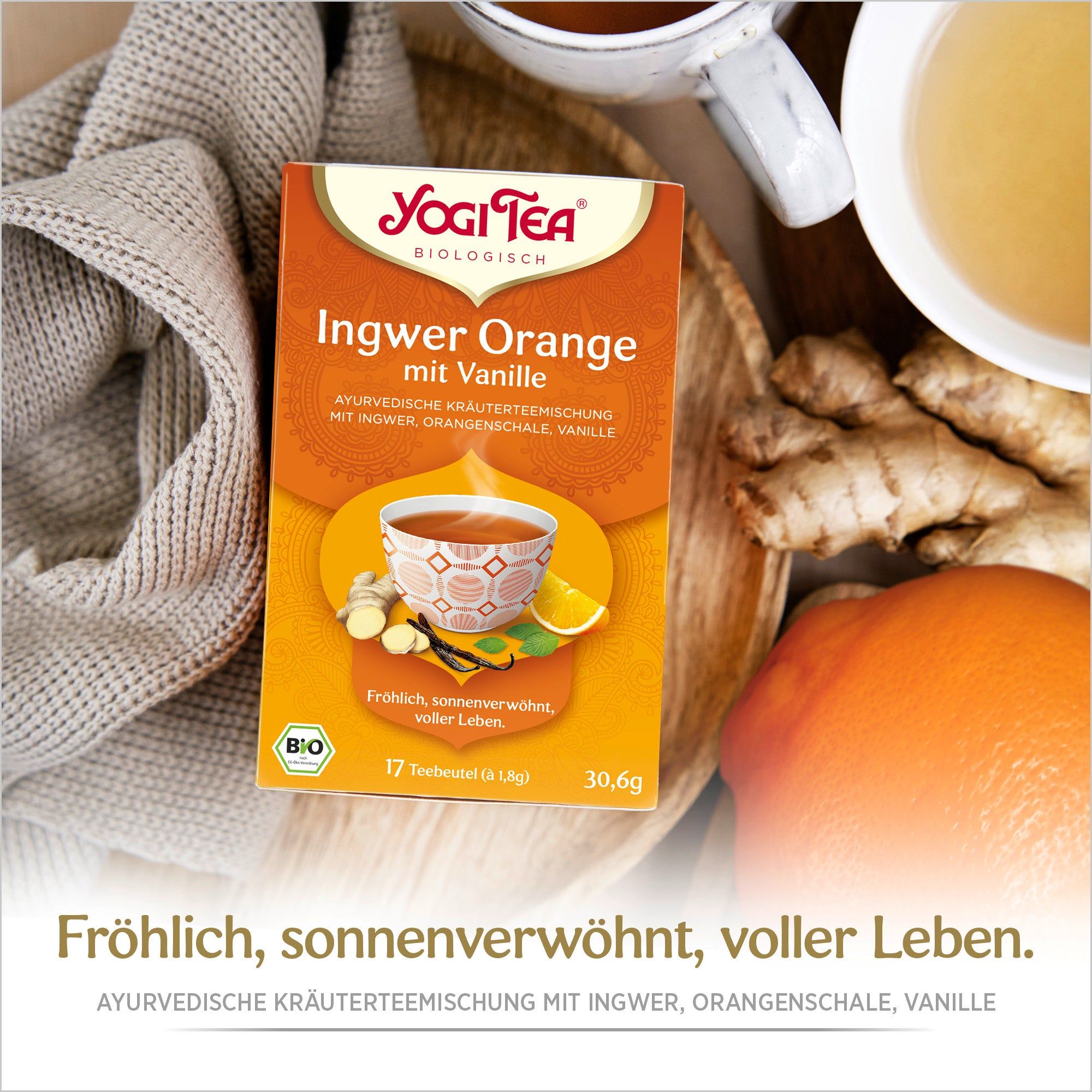 Verpackung Ingwer Orange Tee mit Vanille. Aufdruck: Yogi Tea, Bio, 17 Teebeutel, 30,6g. Daneben Ingwer, Zitrone, Tasse Tee.
