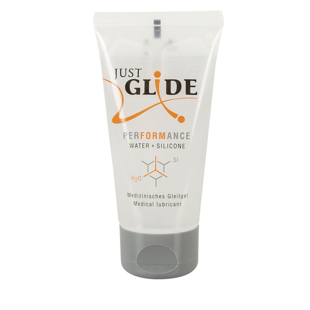 Transparente Tube mit grauer Kappe. Aufschrift: JUST GLIDE PERFORMANCE WATER + SILICONE. Text: Medizinischer Gleitgel.