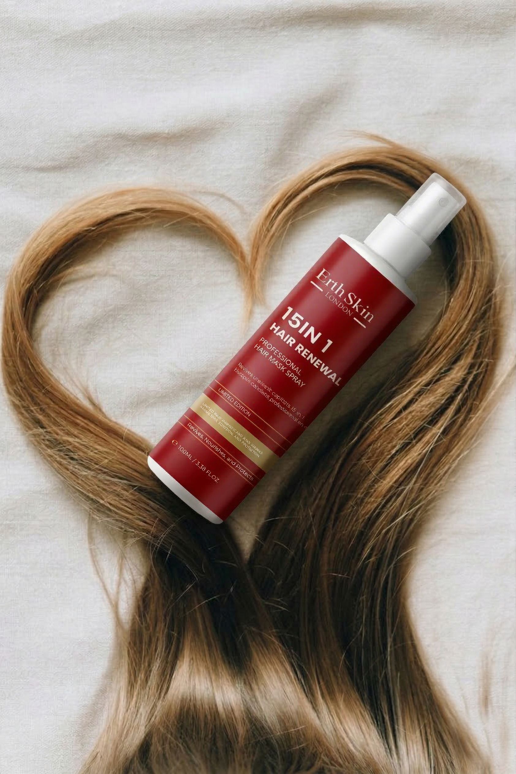 ErthSkin London Spray Masque Réparateur Cheveux 15-in-1, Flasche mit Haaren im Herzform.