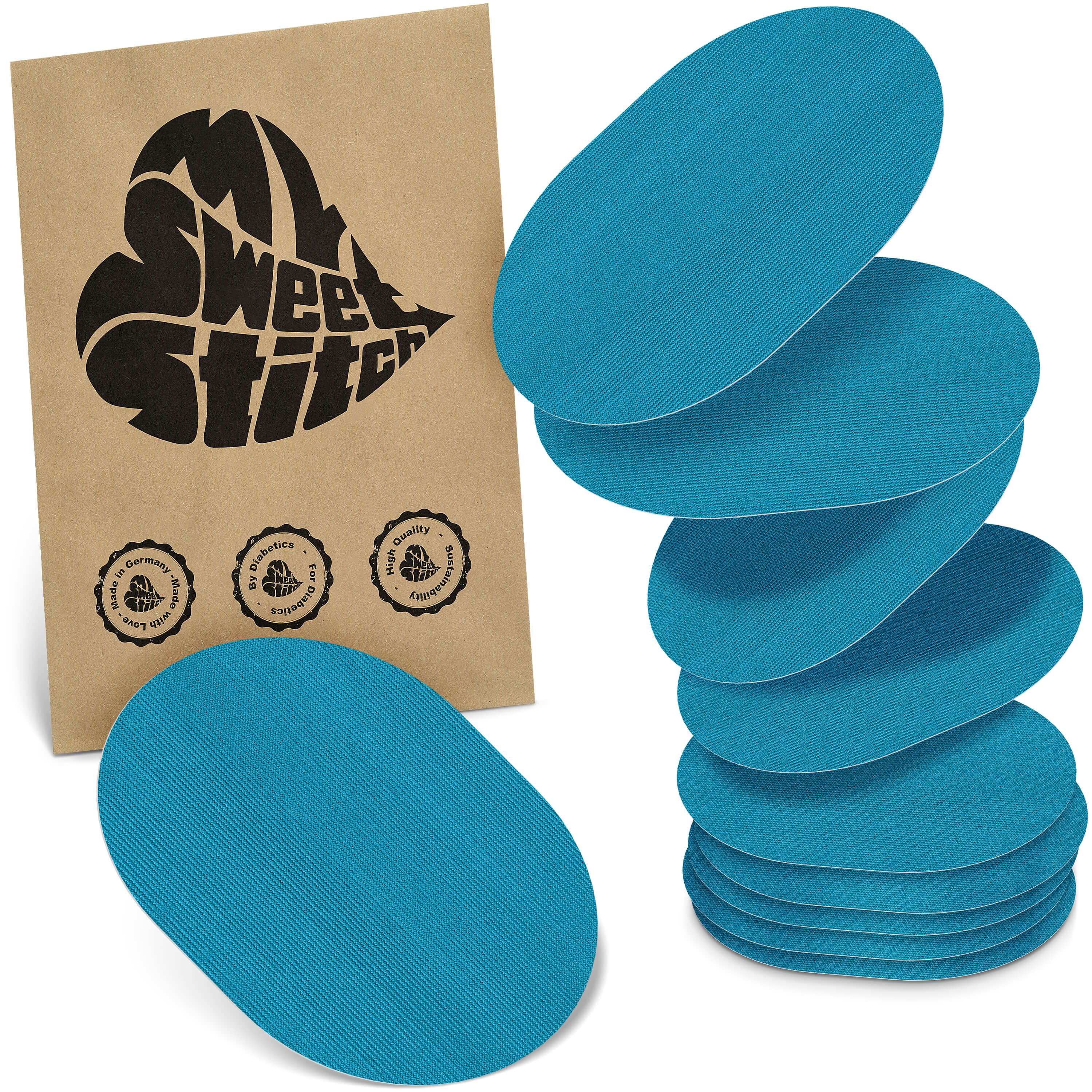 Blau ovale Pflaster. Auf brauner Verpackung steht "MySweetStitch". Siegel: "Made in Germany", "Bio-Qualität".