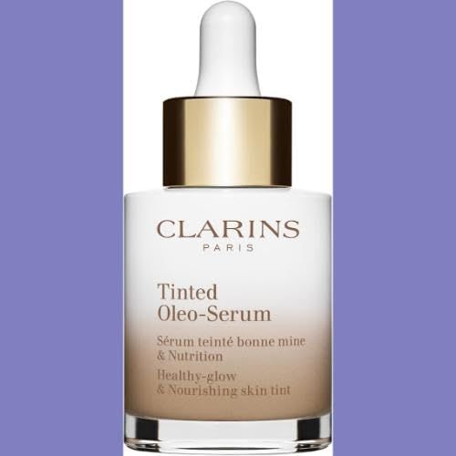 Flakon mit Pipette. Aufschrift: Clarins Paris, Tinted Oleo-Serum. Hintergrund: Lila.