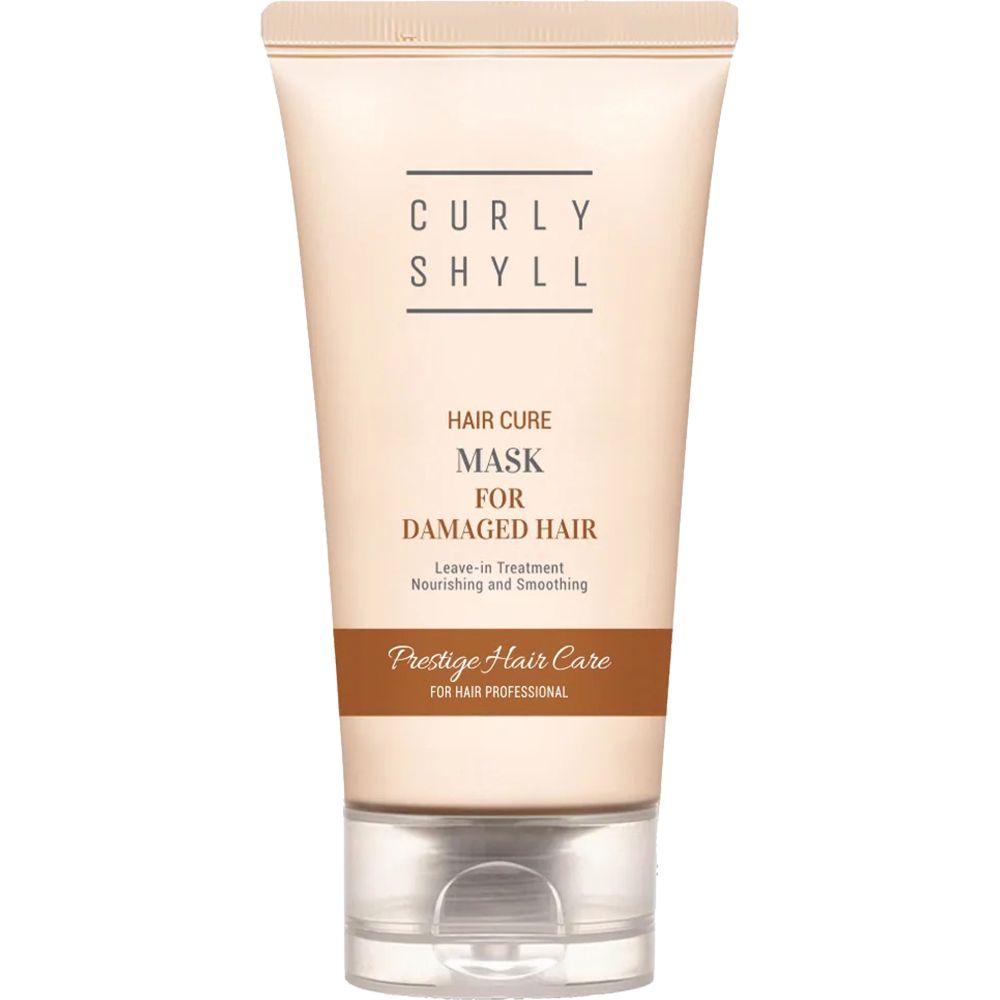 Beige Tube mit Produkttext. Aufschrift: CURLY SHYLL, Hair Cure Mask for Damaged Hair. Leave-in Treatment. Prestige Hair Care.