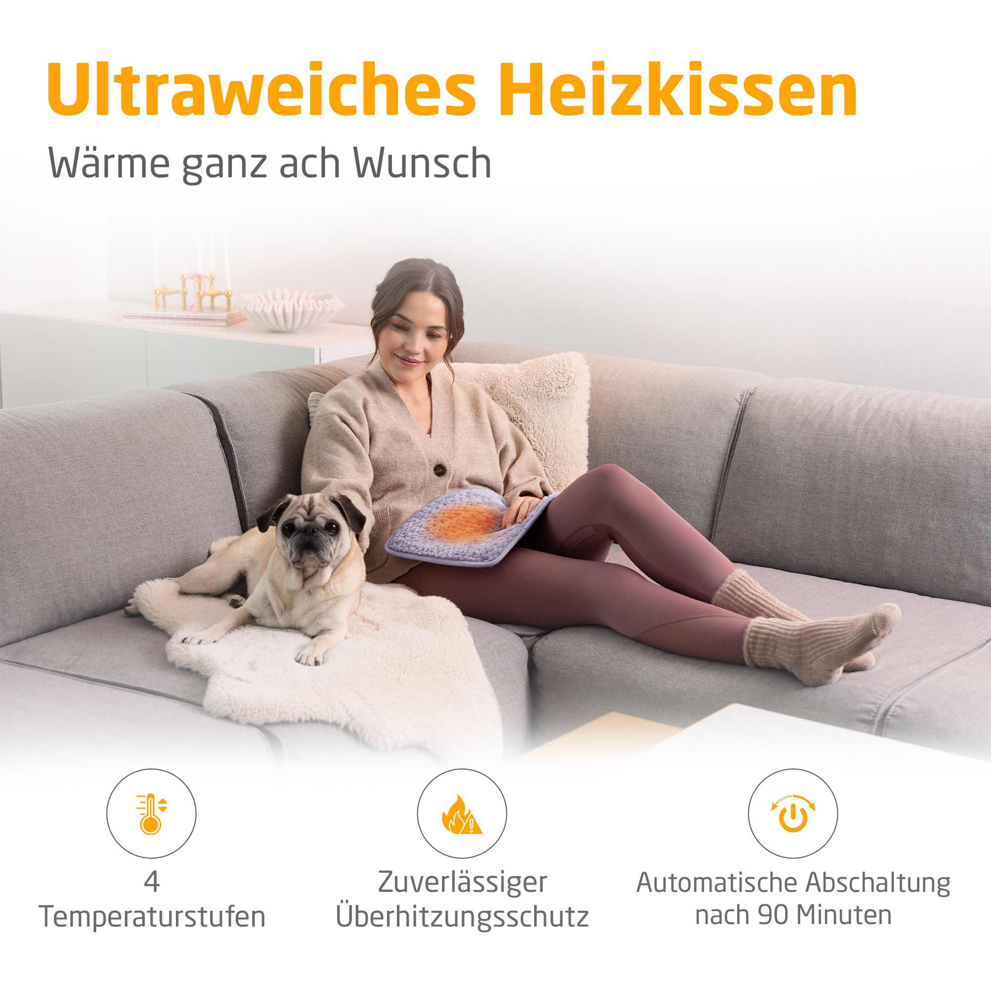 Heizkissen, helllila. Frau sitzt auf Sofa mit Hund. 4 Temperaturstufen, Überhitzungsschutz, automatische Abschaltung.