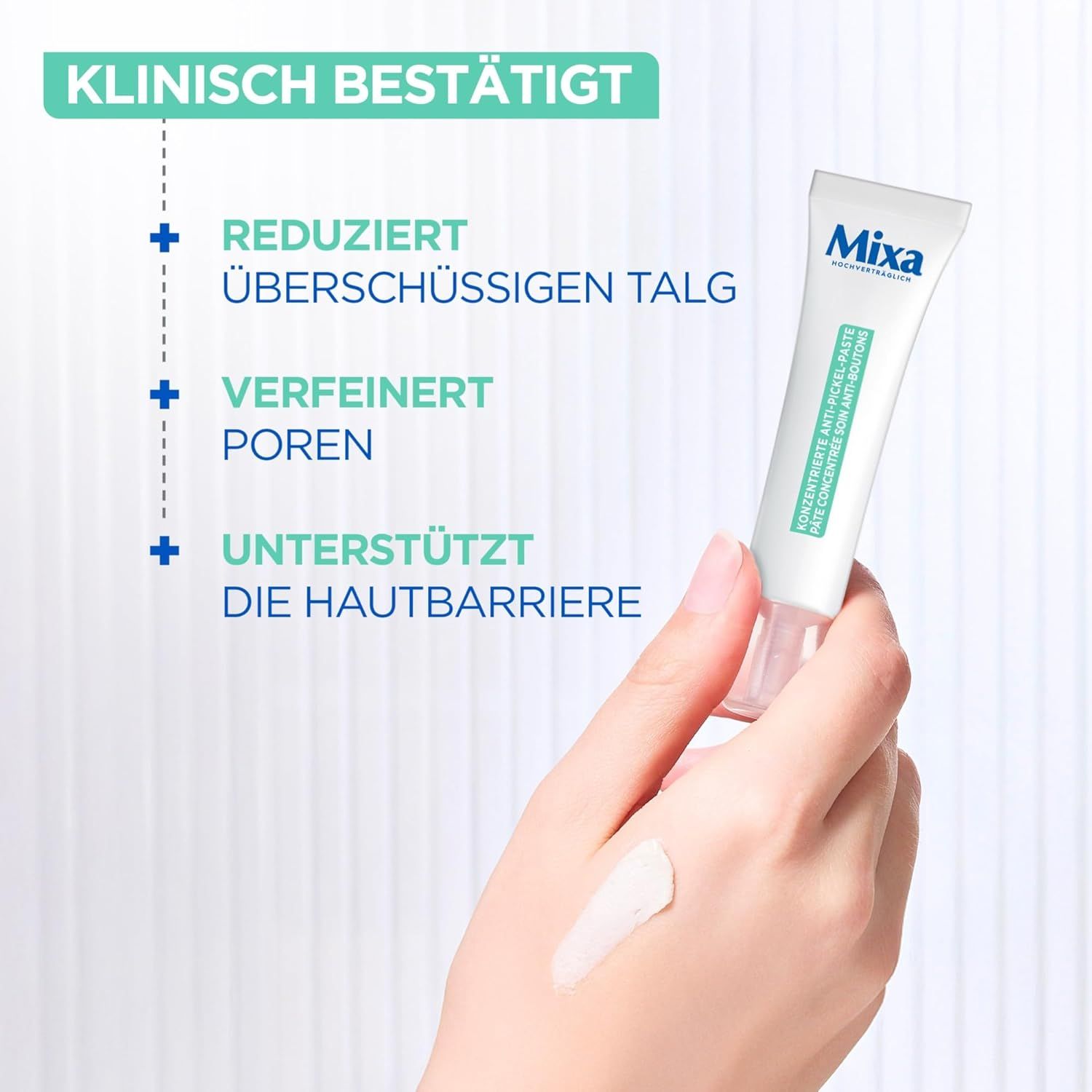 Weiße Tube Mixa. Konzentrierte Anti-Pickel-Paste. Hand mit Produkt auf der Haut. Text: Klinisch bestätigt.