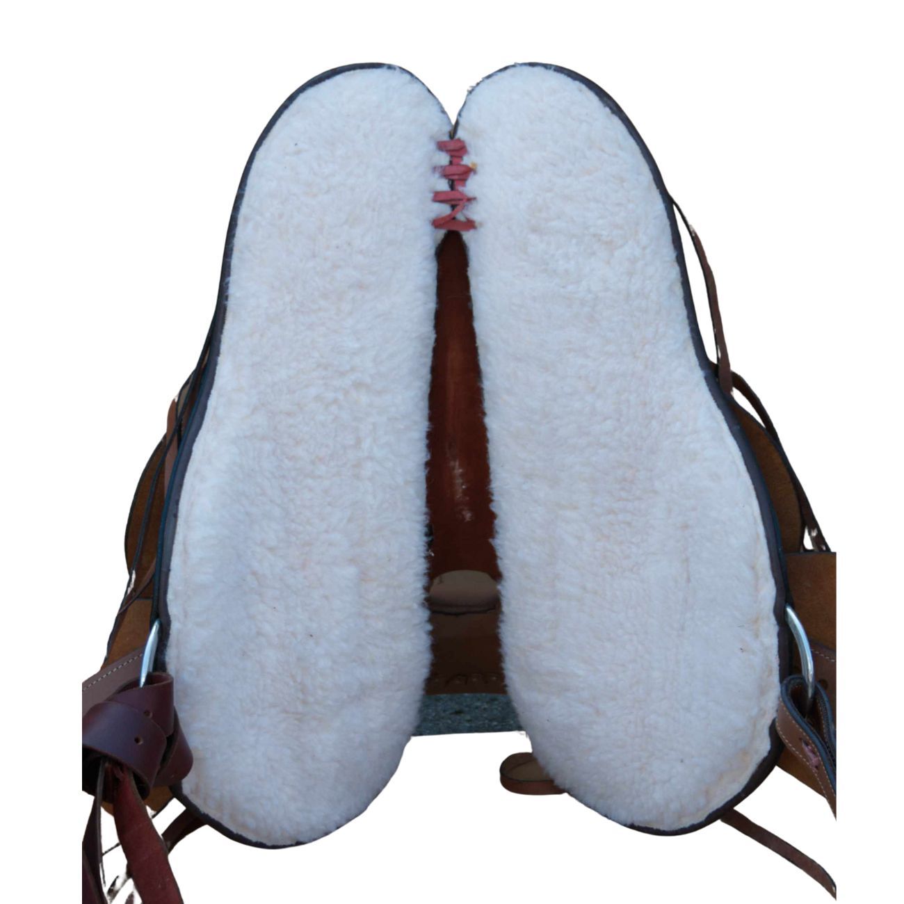 Unterseite eines Westernsattels mit weißem Fell. Rote Naht in der Mitte.