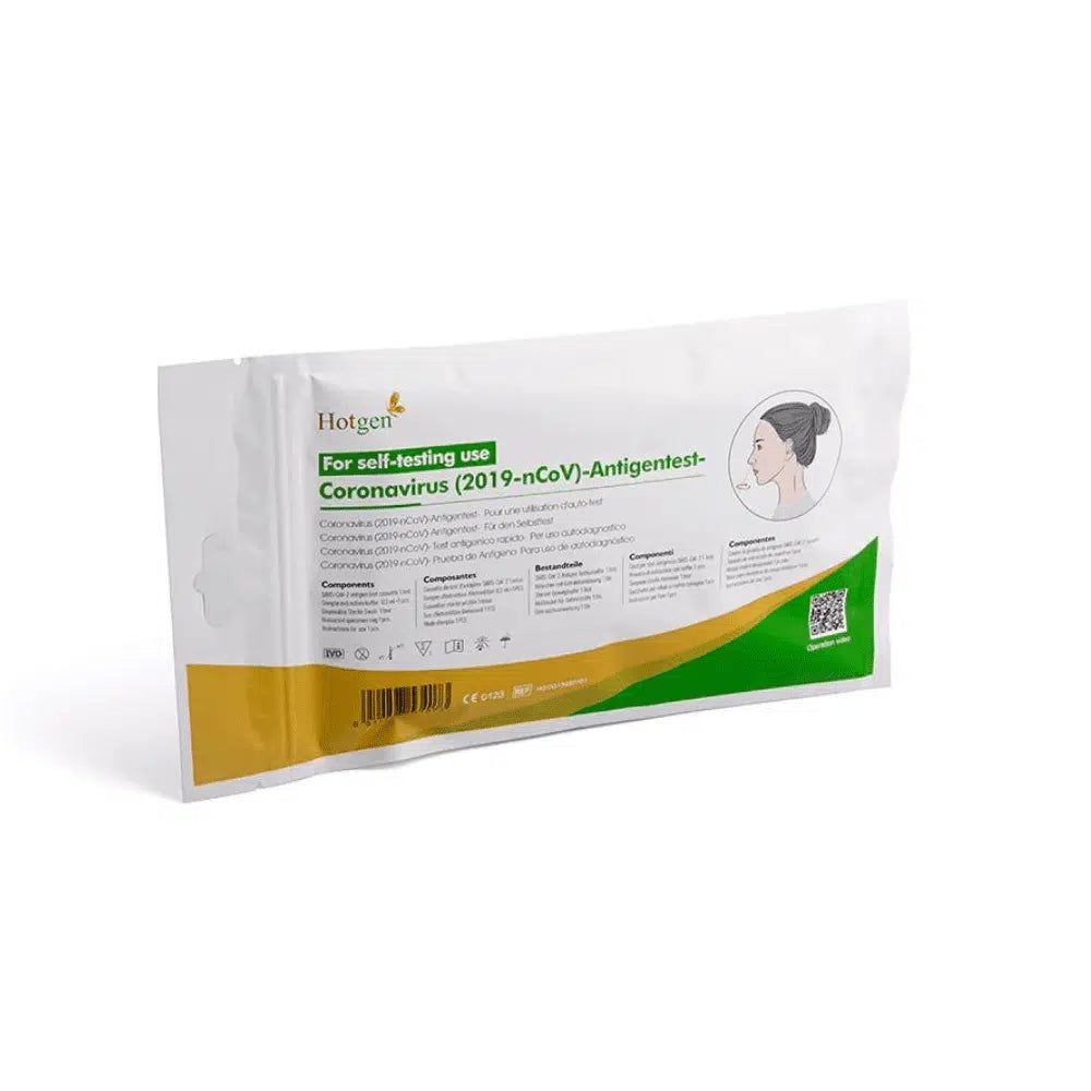 Verpackung des Hotgen Sars-CoV-2 Antigen Laien Schnelltest. Weißer Beutel mit grünen und gelben Elementen. Aufdruck mit Produktinformationen.