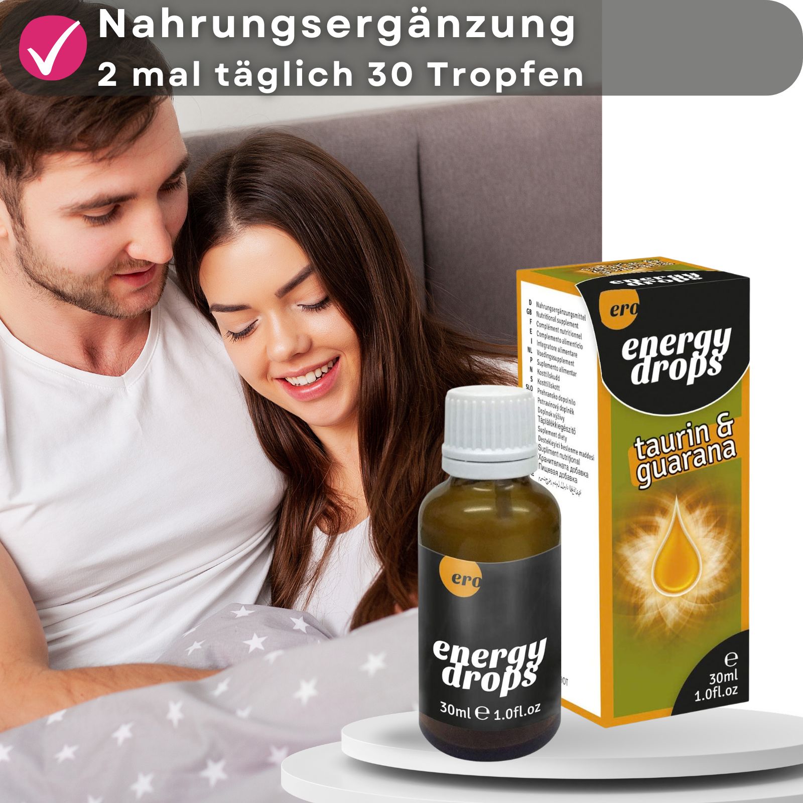 Paar im Bett, neben einer Flasche und Verpackung. Aufschrift: energy drops, Taurin & Guarana. Banner mit Text: Nahrungsergänzung, 2 mal täglich 30 Tropfen.