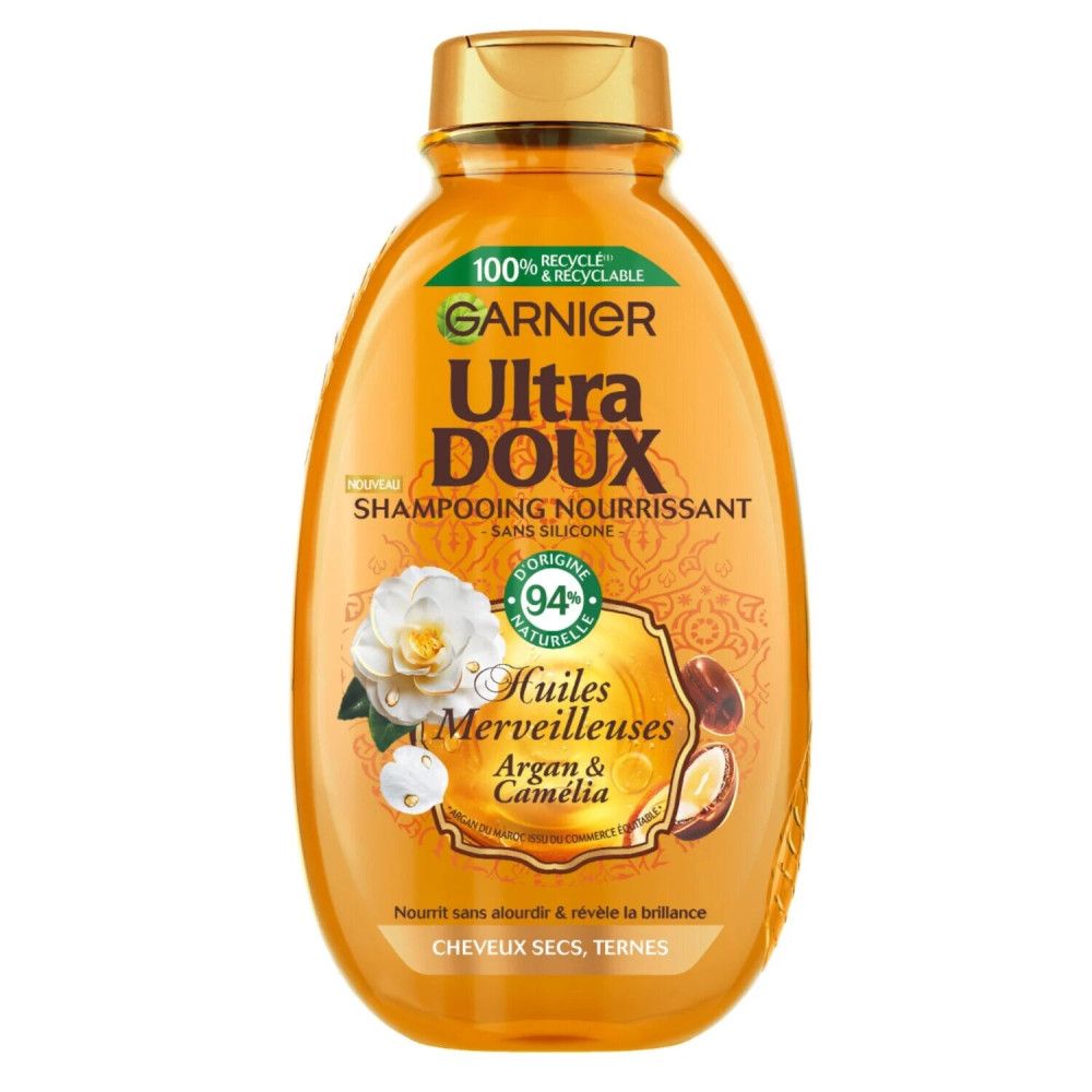 Orangefarbene Shampoo-Flasche. Aufschrift: Garnier Ultra Doux, Huiles Merveilleuses, Argan & Camélia. 94% natürliche Inhaltsstoffe.