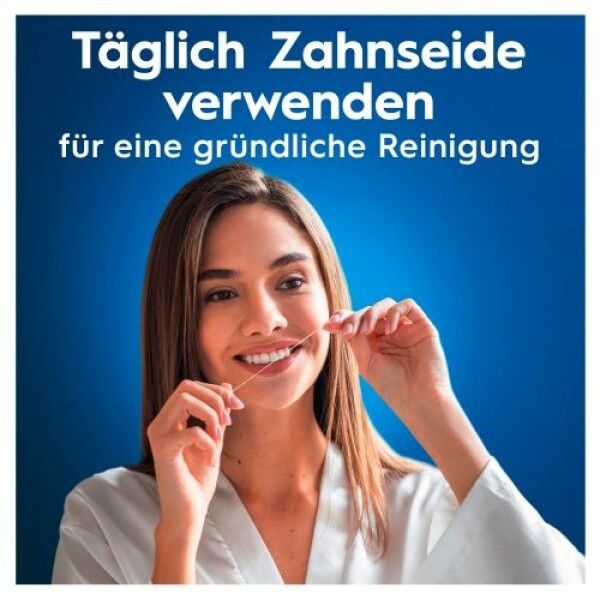 Frau verwendet Zahnseide. Nahaufnahme einer Frau, die Zahnseide benutzt. Text: Täglich Zahnseide verwenden für eine gründliche Reinigung.