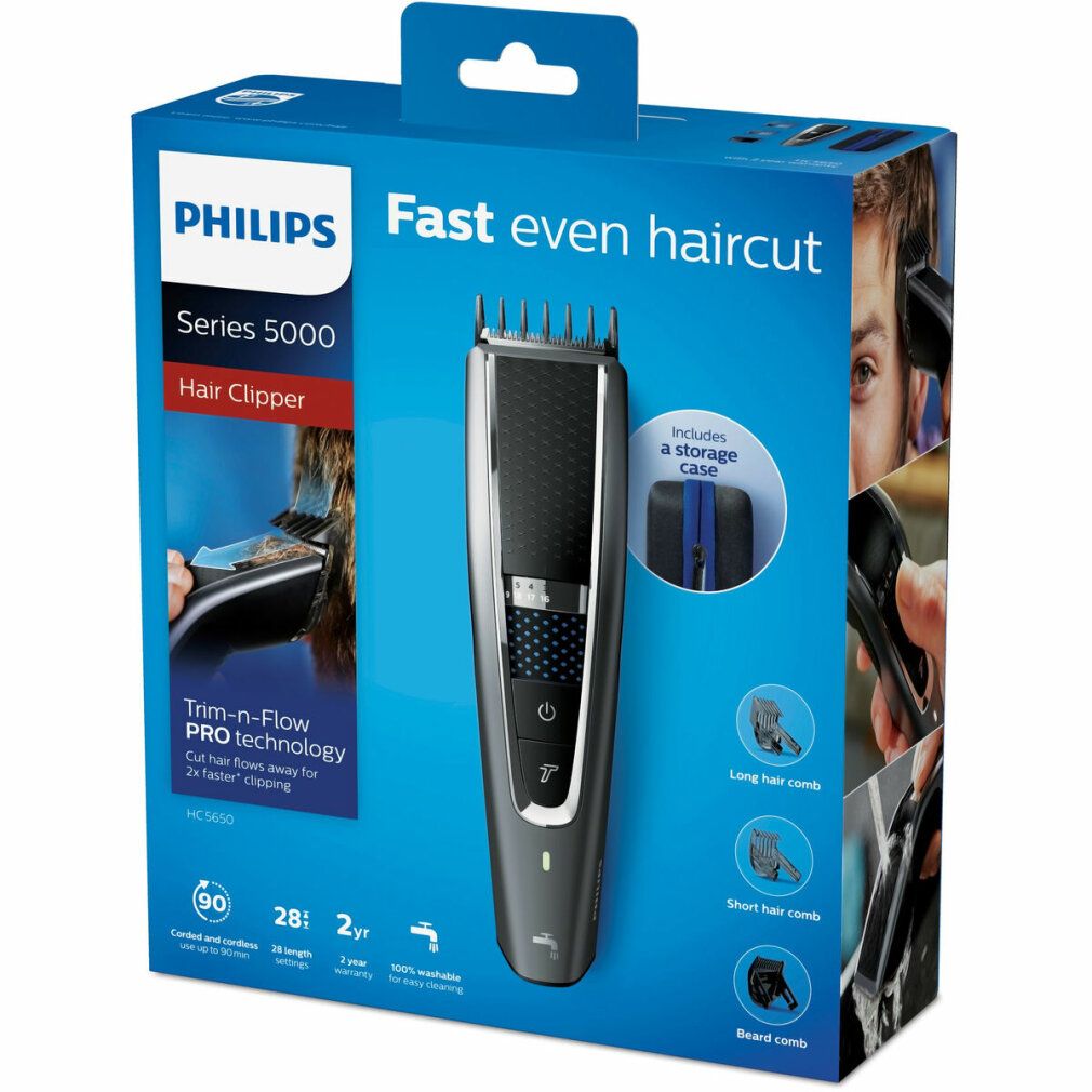 Philips Haarschneider Series 5000 in Verpackung. Schwarzes Gerät, blaue Akzente. Enthält Aufsätze und Aufbewahrungstasche. Text: "Fast even haircut".