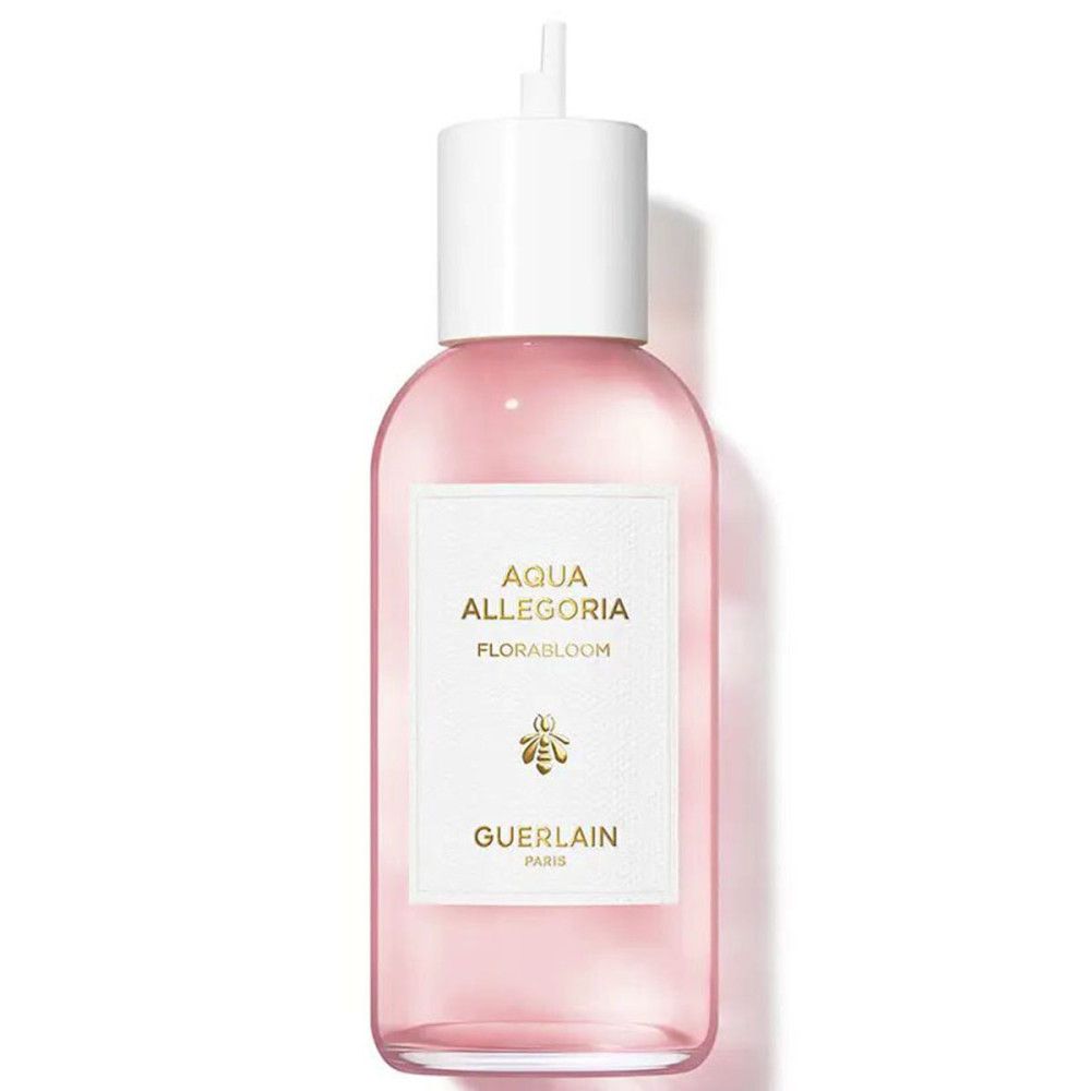 Rosa Flüssigkeit in einer Flasche mit weißem Verschluss. Aufkleber mit Text: Aqua Allegoria Florabloom, Biene, Guerlain Paris.