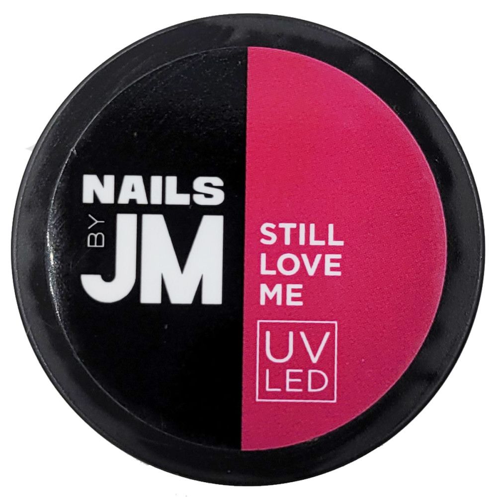Runder Behälter mit schwarzem und pinkfarbenem Bereich. Aufschrift "NAILS BY JM", "STILL LOVE ME" und "UV LED".