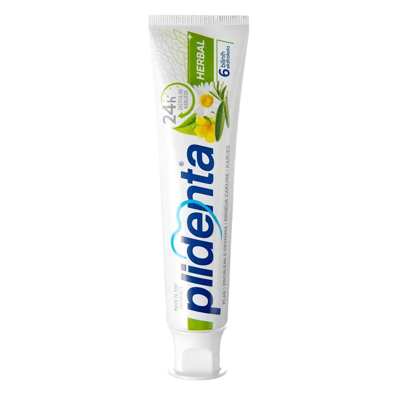 Zahncreme-Tube, weiß mit grünen und blauen Akzenten. Aufschrift "plidenta" und "Herbal". Abbildung von Blüten und Blättern.
