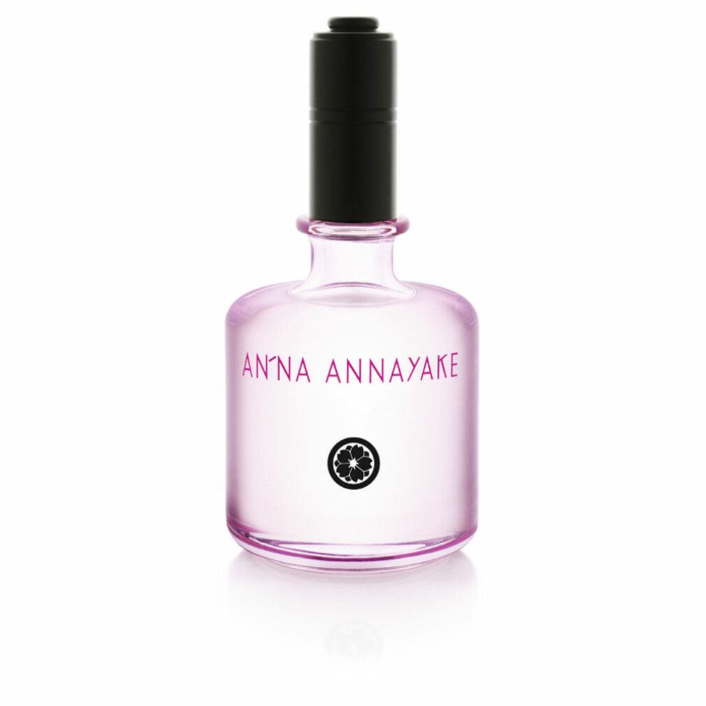 Parfümflasche mit schwarzem Verschluss. Rosa Flüssigkeit. Aufschrift: ANNA ANNAYAKE und Logo. Klarer Glasbehälter.