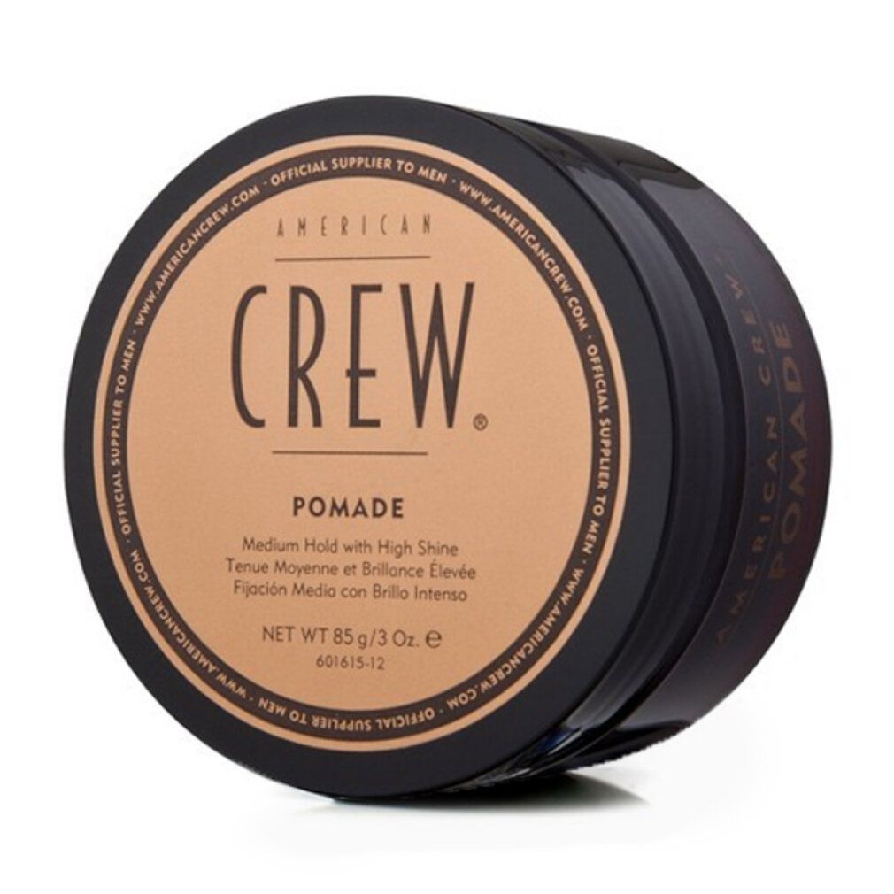 Runde, schwarze Dose mit braunem Deckel. Aufschrift: AMERICAN CREW. Pomade. Netto 85 g/3 Oz.
