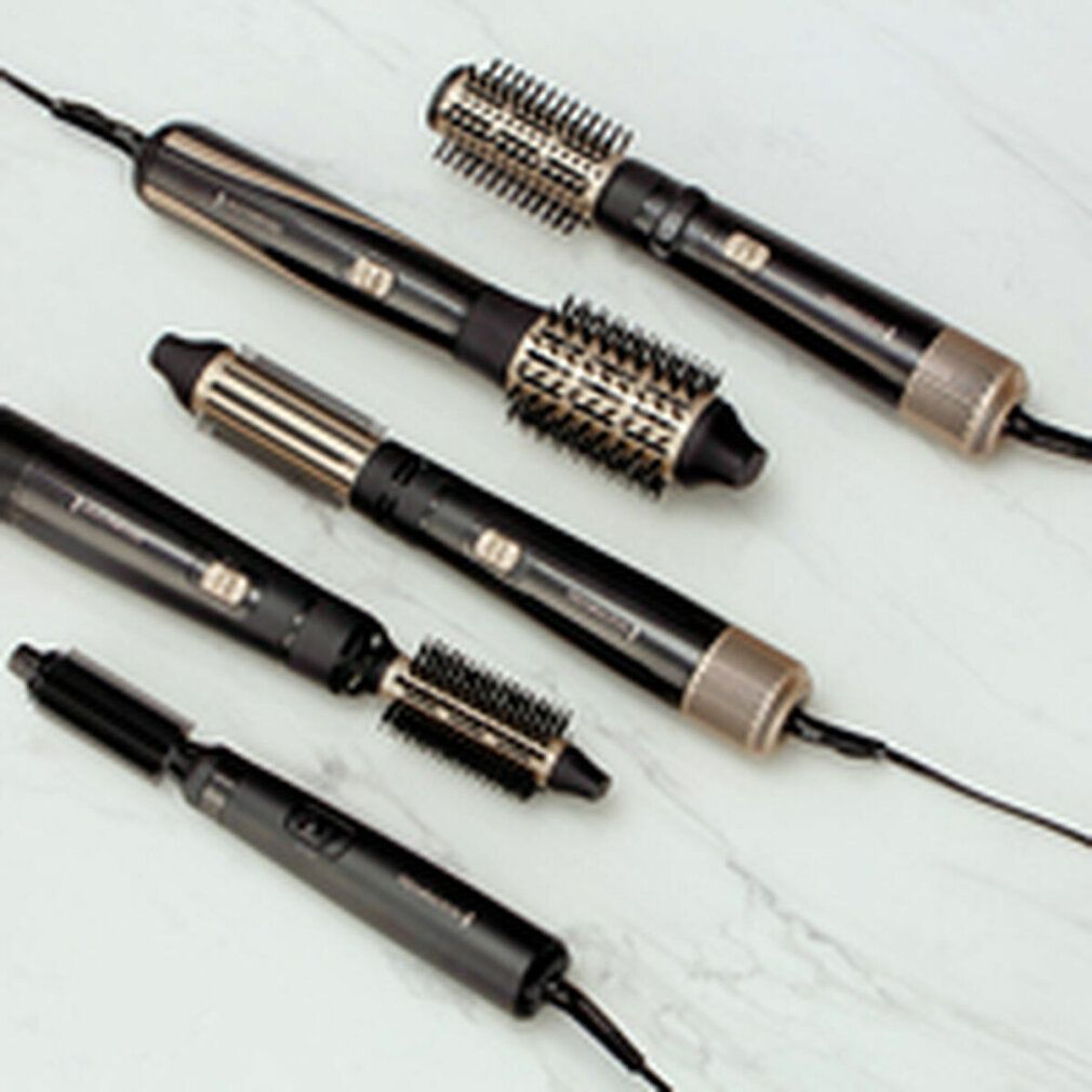 Mehrere Remington Multi-Warmluftstyler mit verschiedenen Aufsätzen. Schwarz und goldfarben. Aufsätze und Geräte mit Kabel.