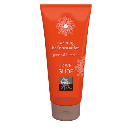 Orange Tube mit braunem Deckel. Aufschrift: Love Glide, warming body sensation, personal lubricant. Logo.