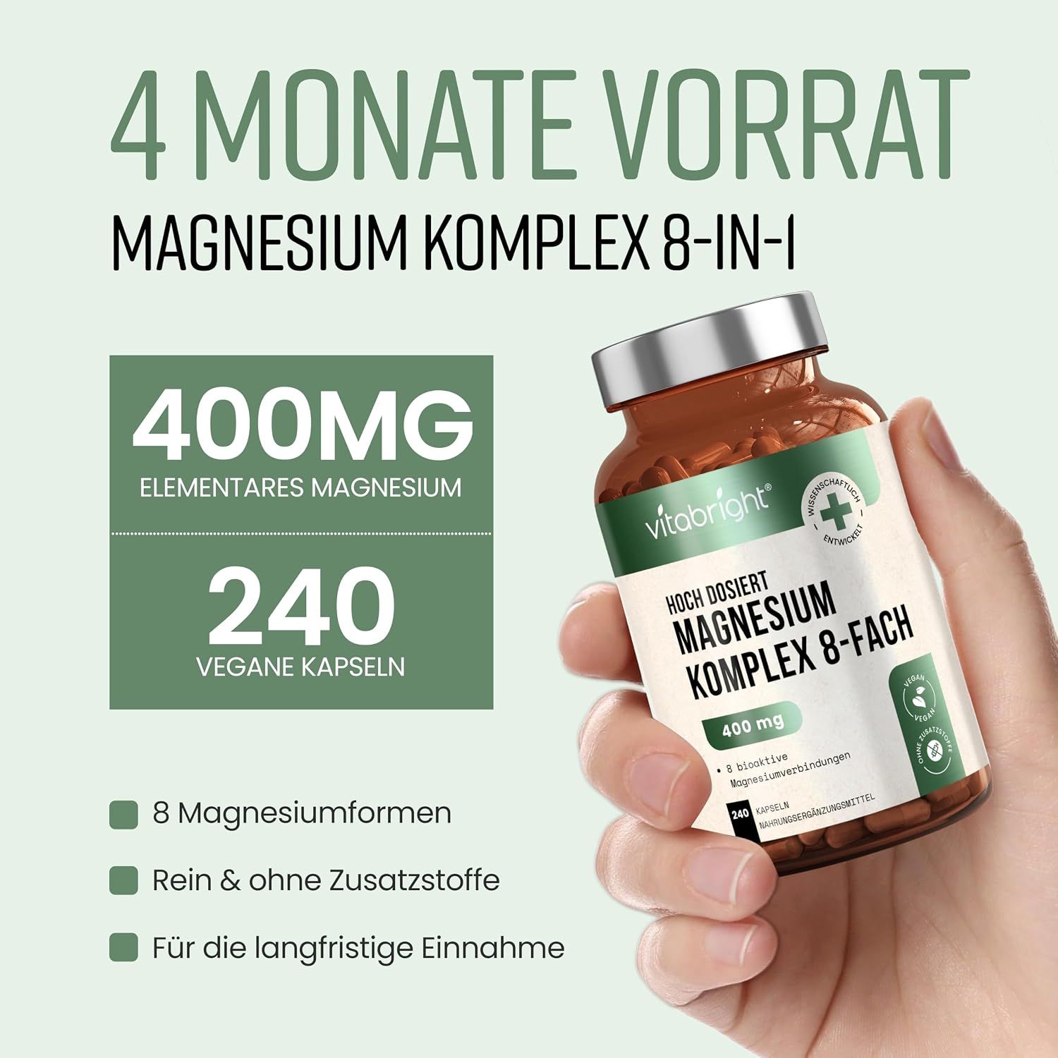 Hand hält Flasche "Magnesium Komplex 8-fach", 400mg, 240 vegane Kapseln.